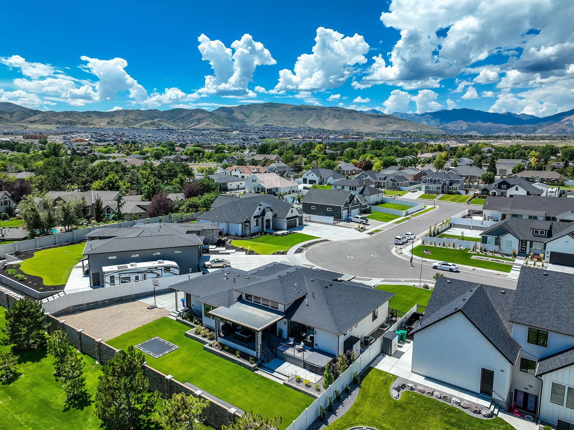 An aerial view of a residential neighborhood with mountains in the background