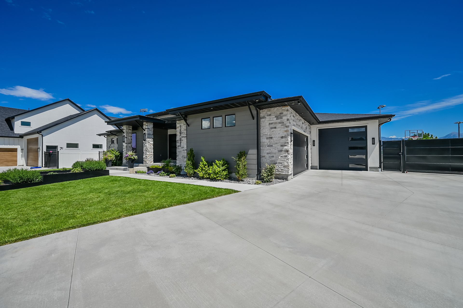 A large house with a concrete driveway in front of it.