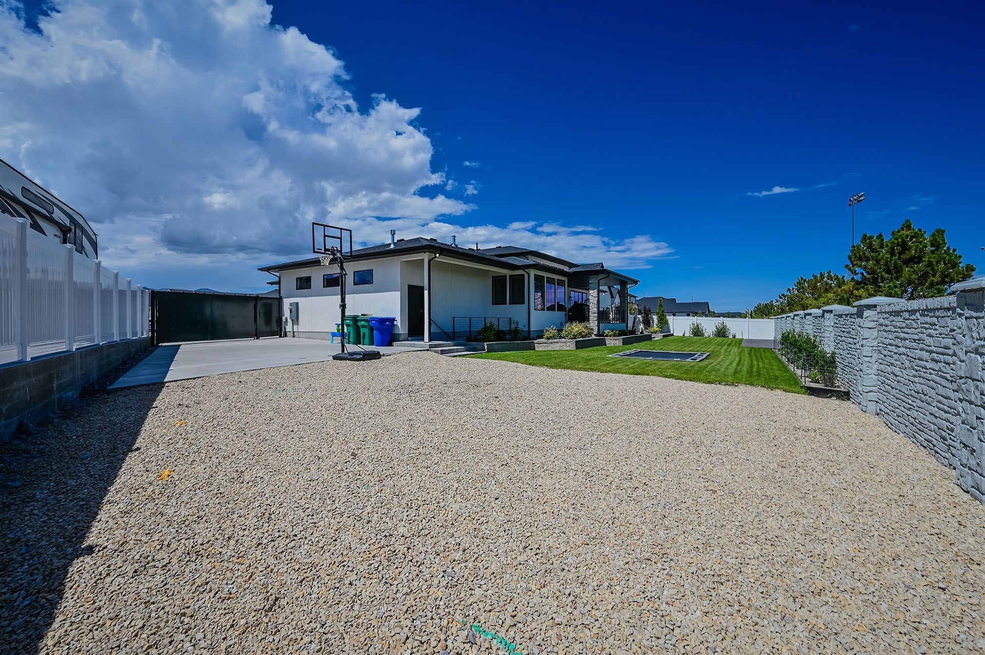 A house with a gravel driveway in front of it.
