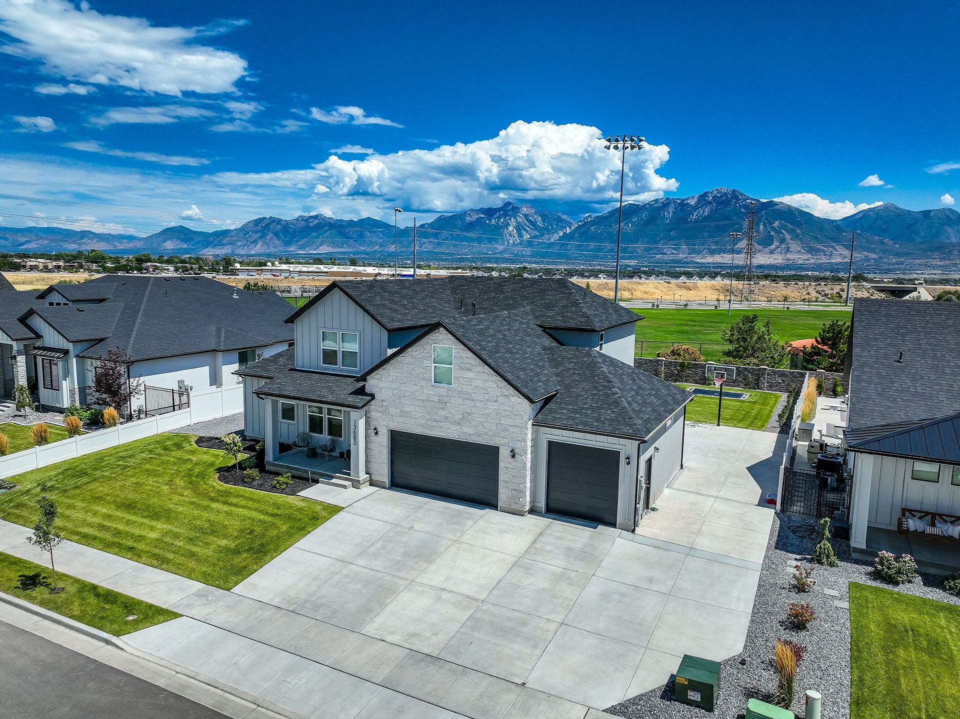 An aerial view of a house with mountains in the background.