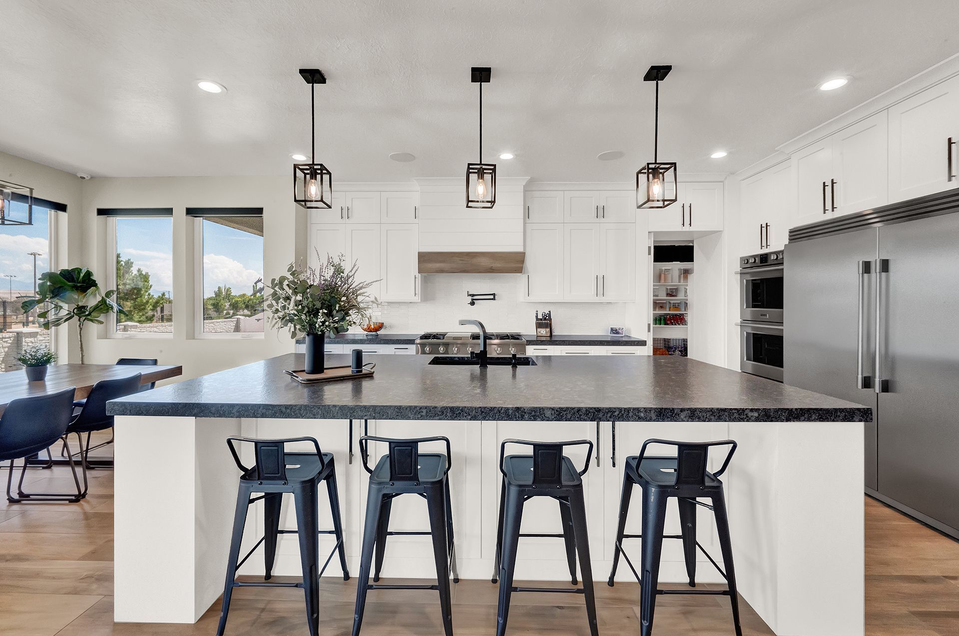 A kitchen with a large island and stools