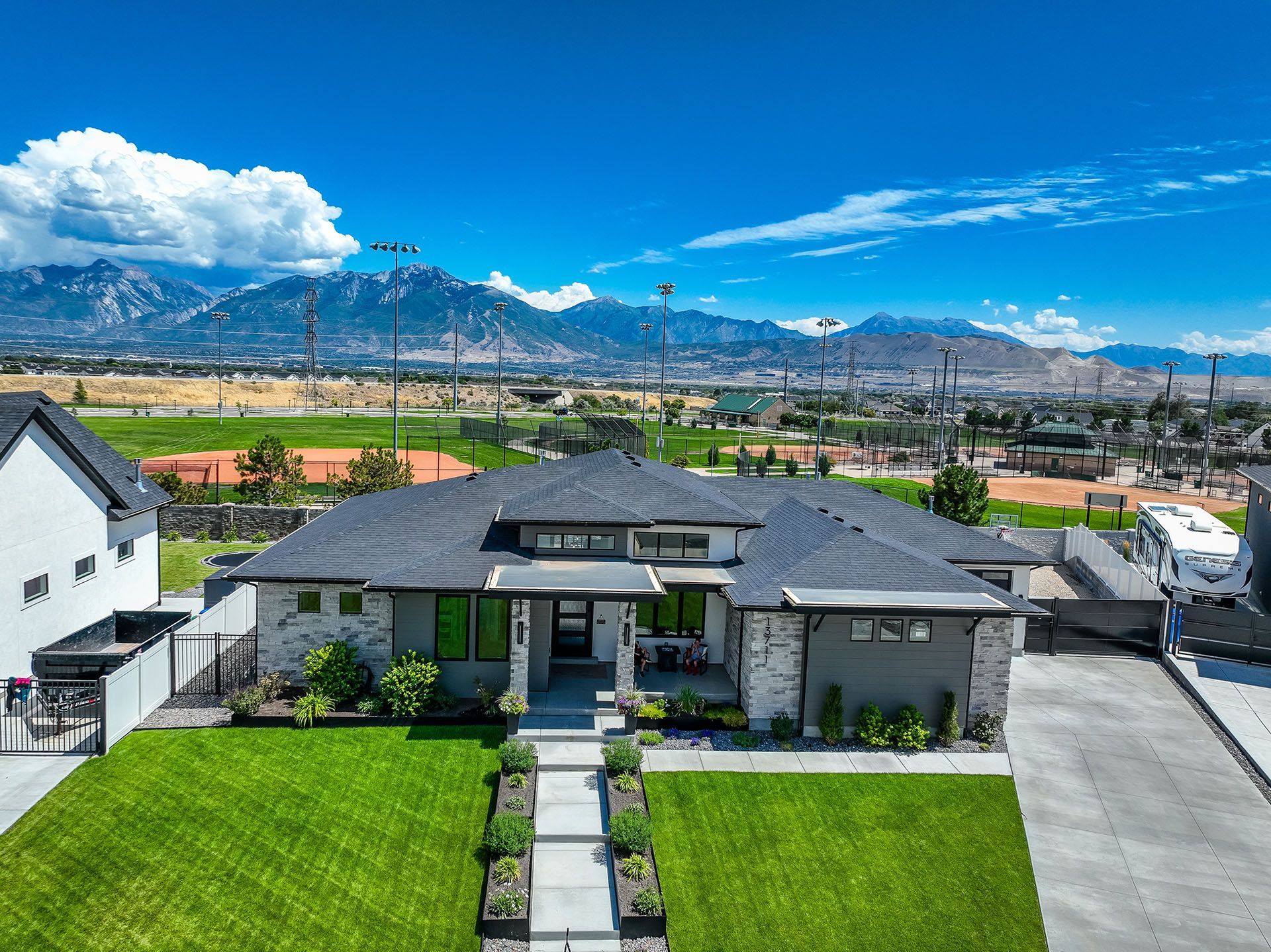 An aerial view of a house with mountains in the background.