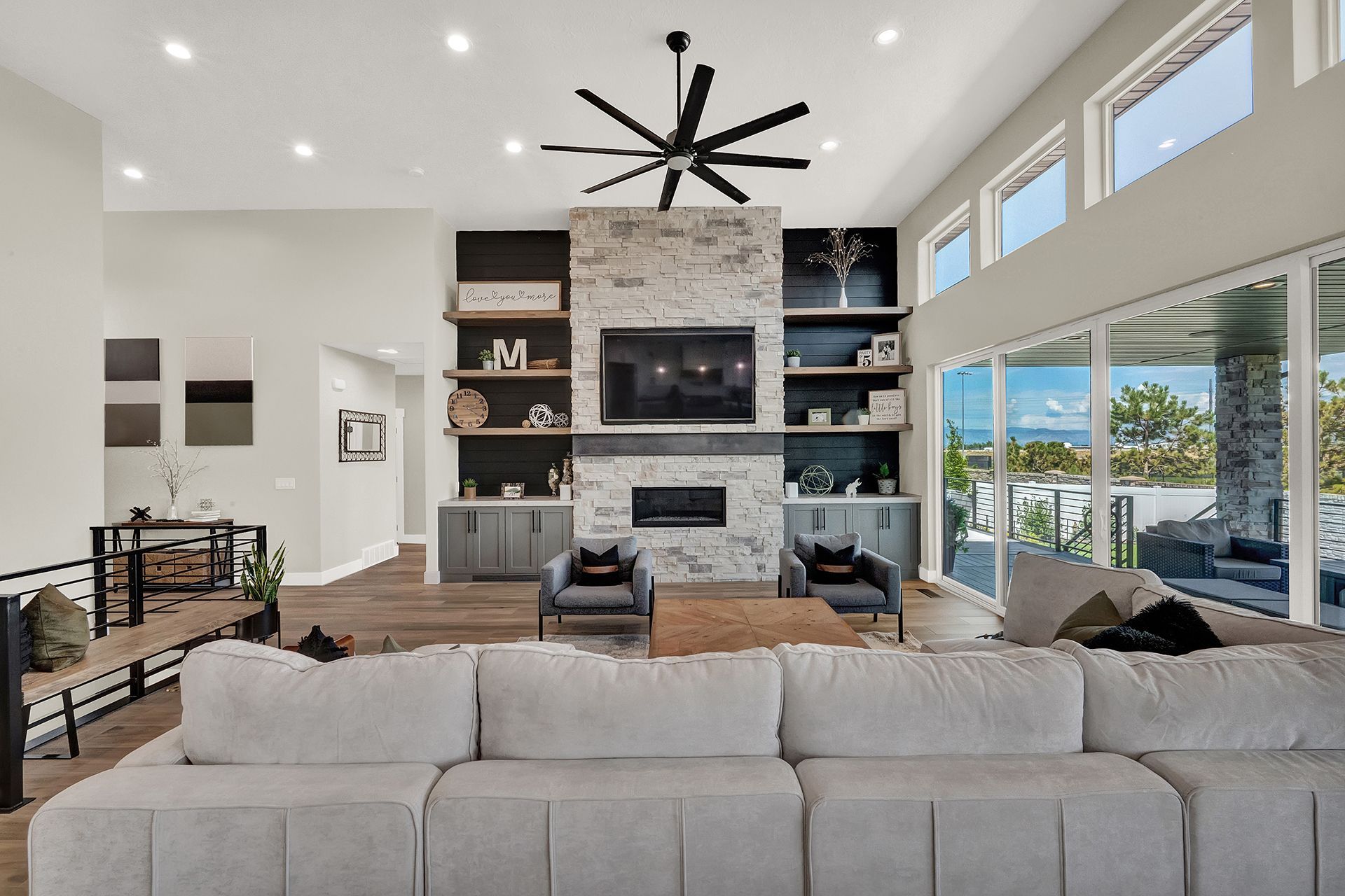 A living room with a couch and a ceiling fan