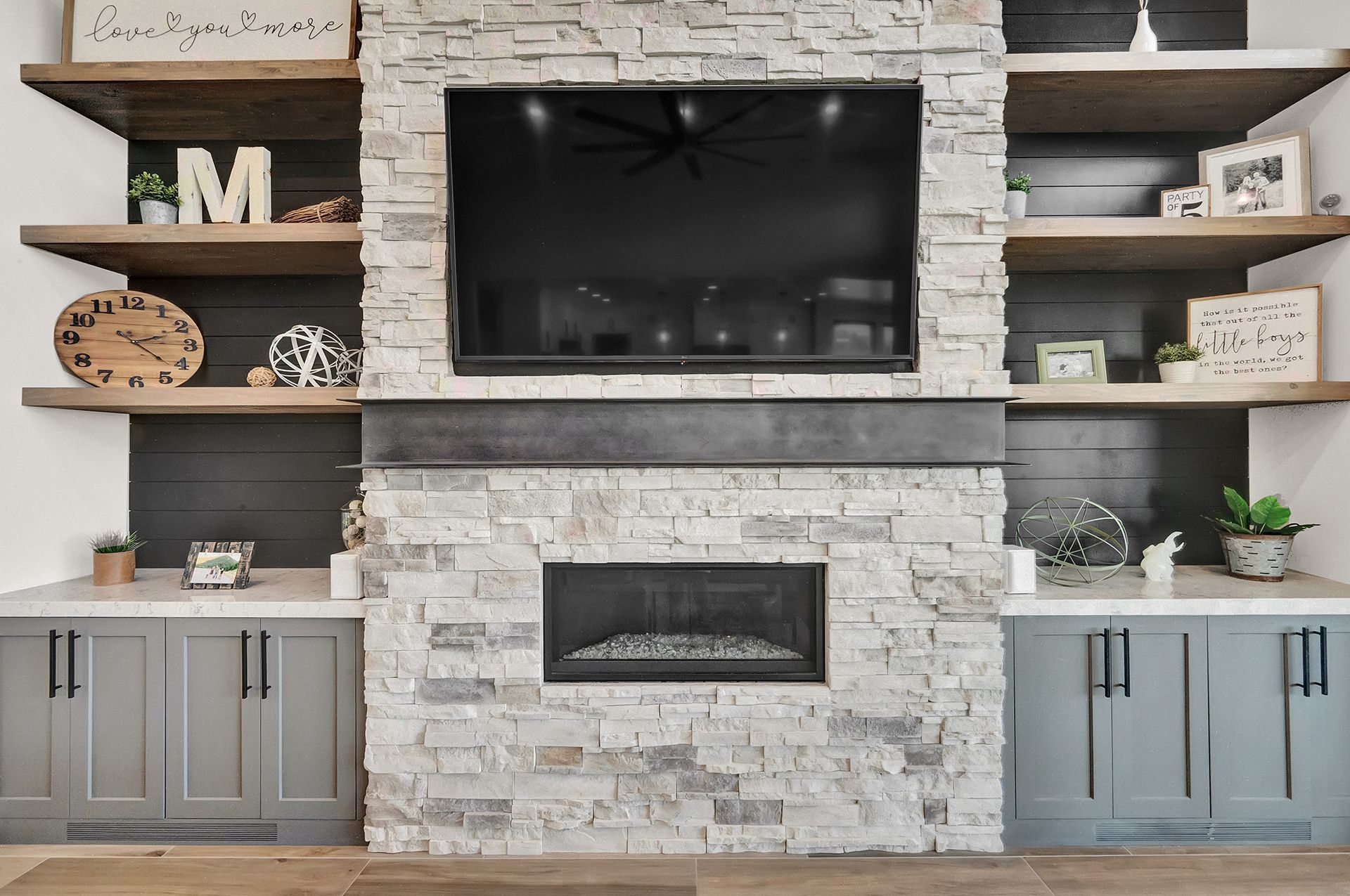 A living room with a fireplace and a flat screen tv.