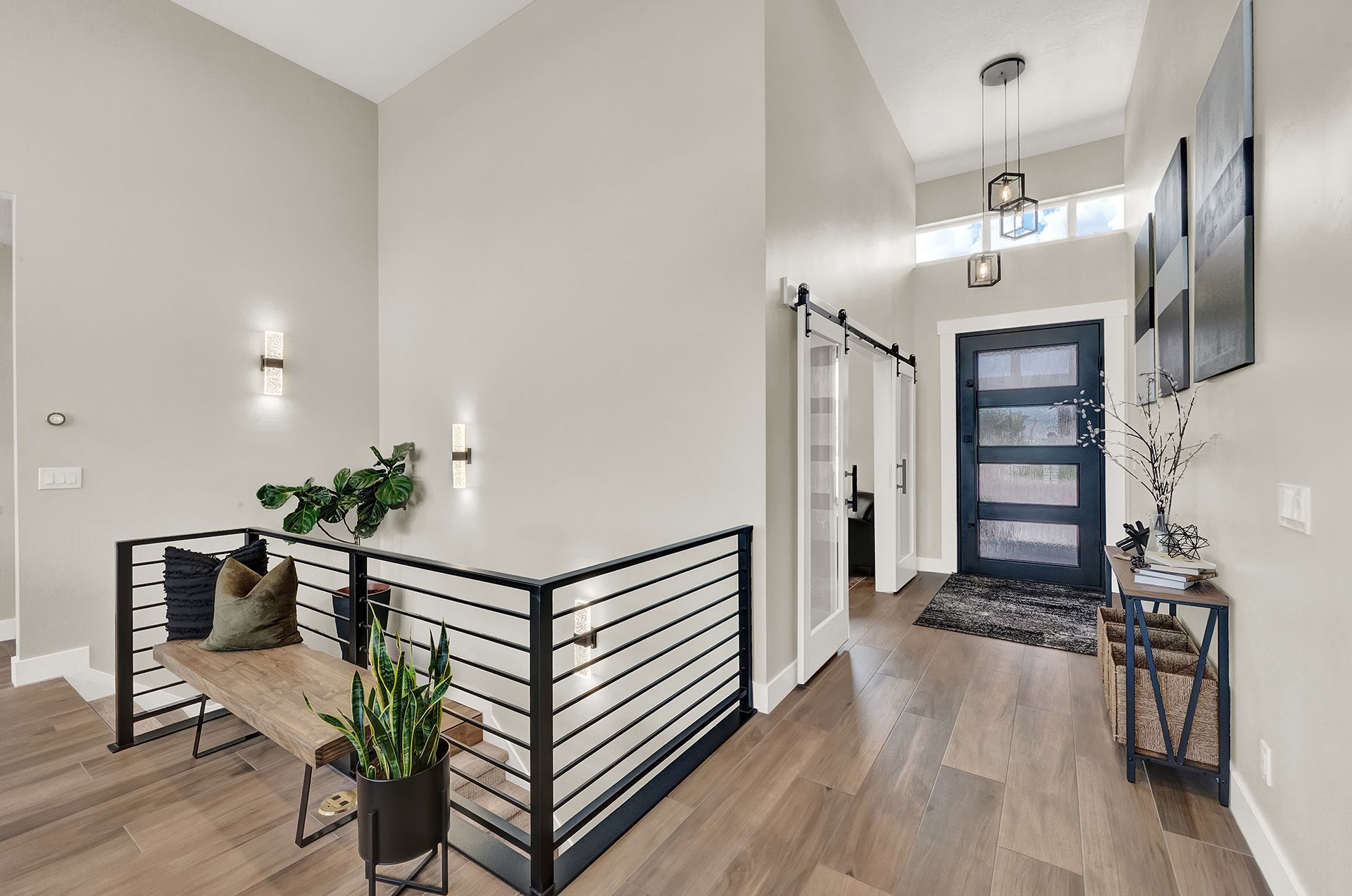A hallway in a house with a sliding glass door and a bench.