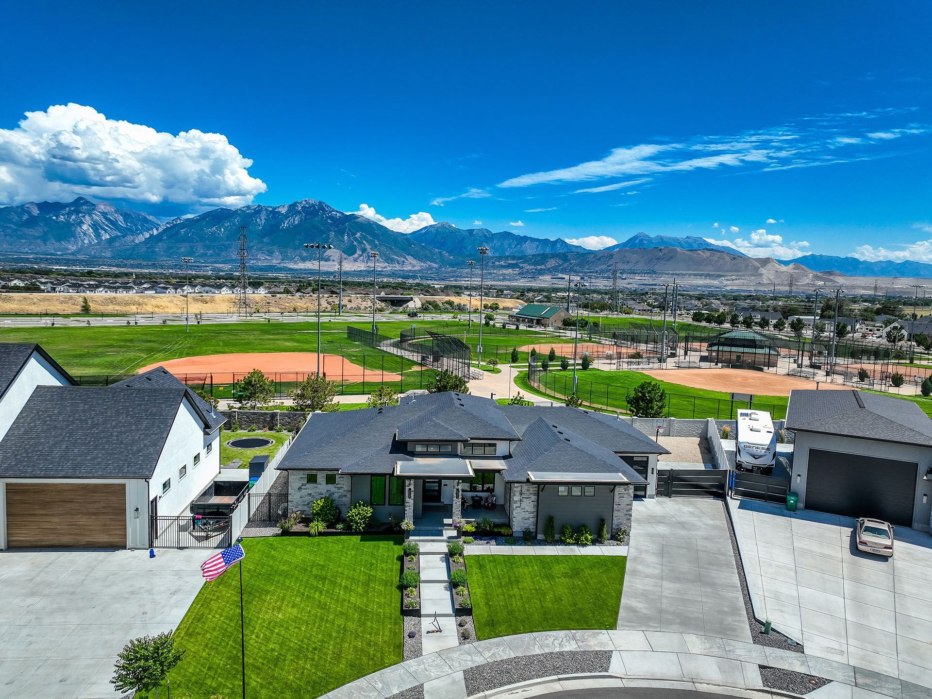 An aerial view of a house with mountains in the background