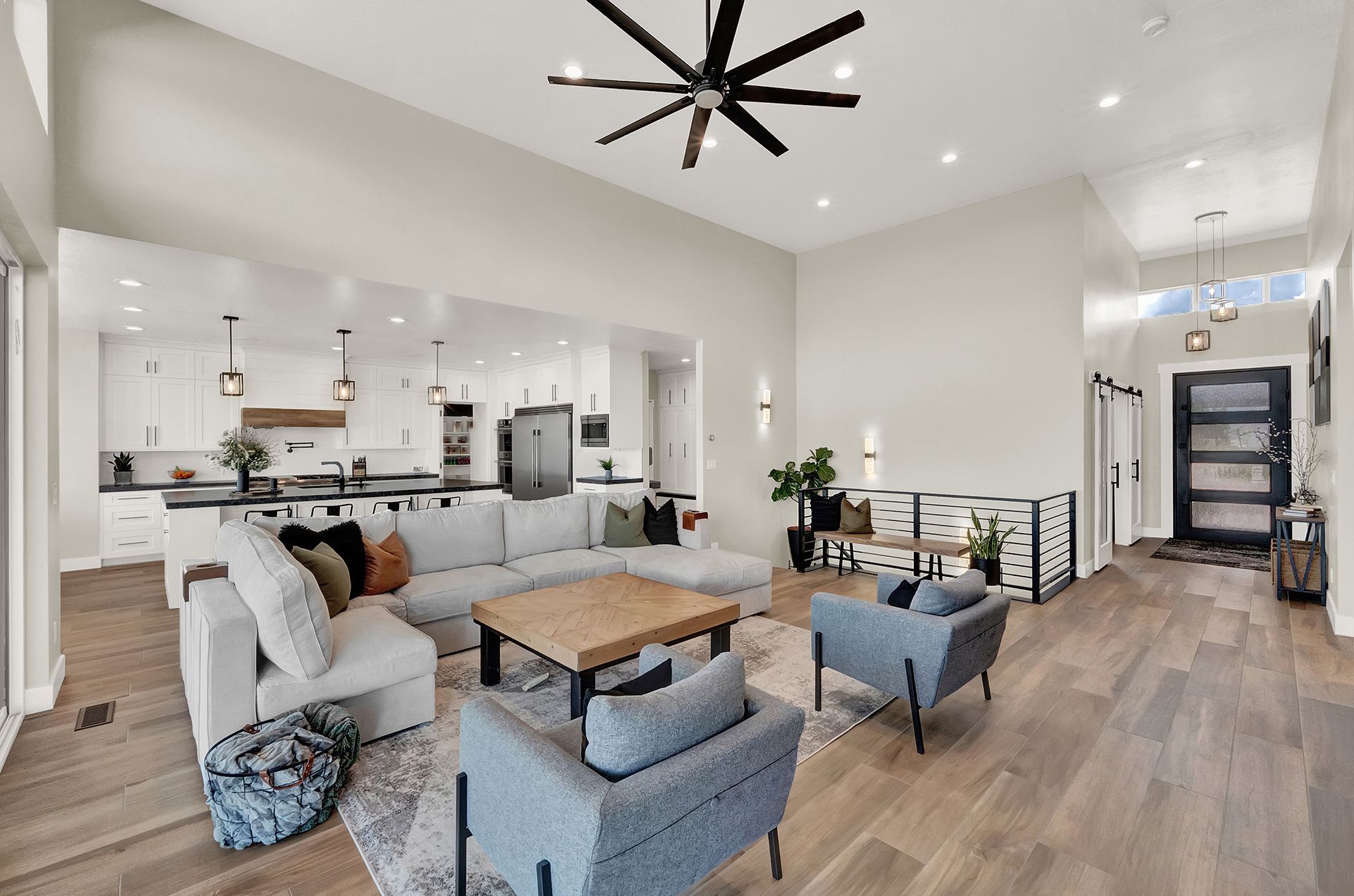 A living room filled with furniture and a ceiling fan.