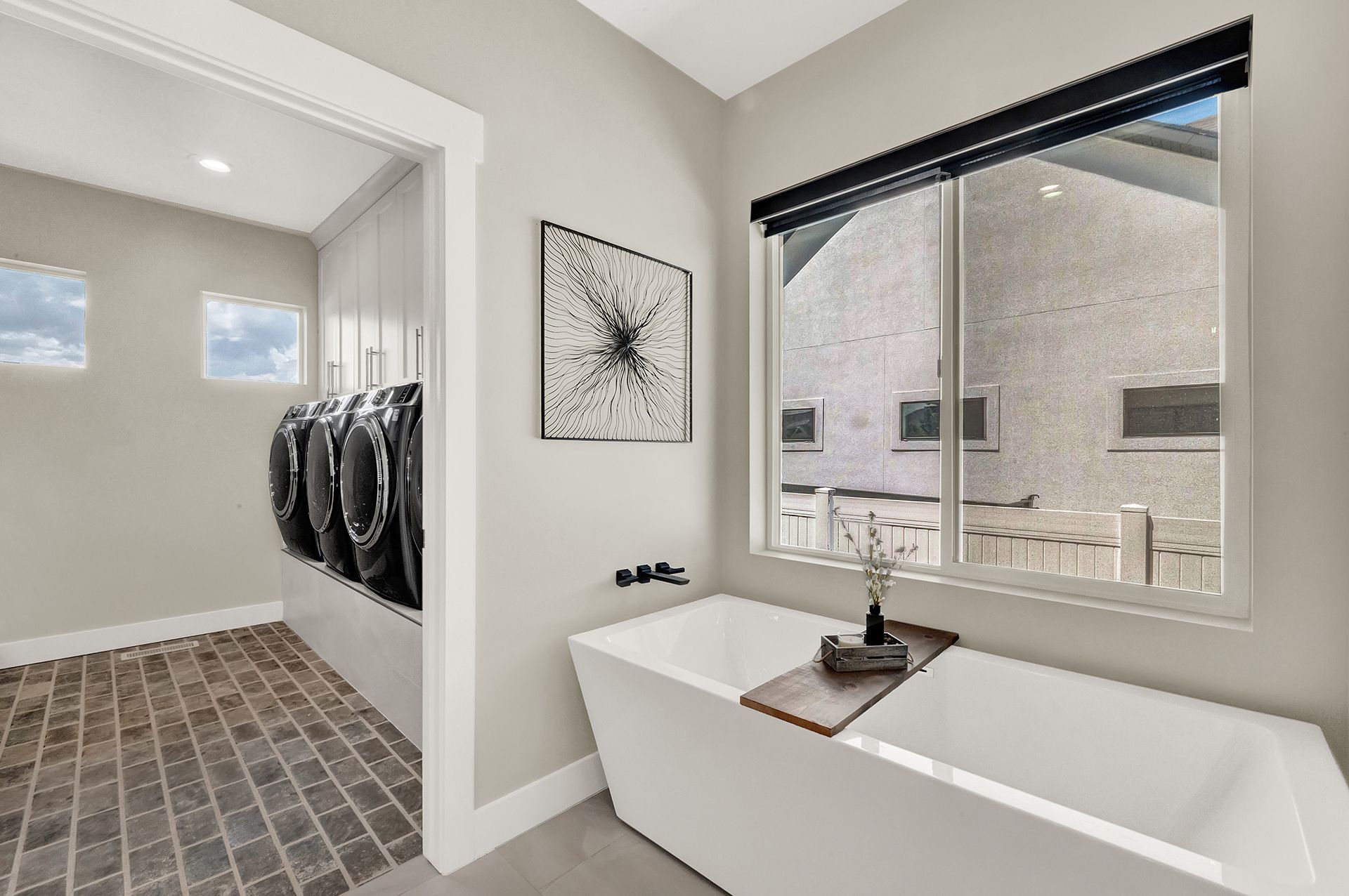 A bathroom with a tub and a window.