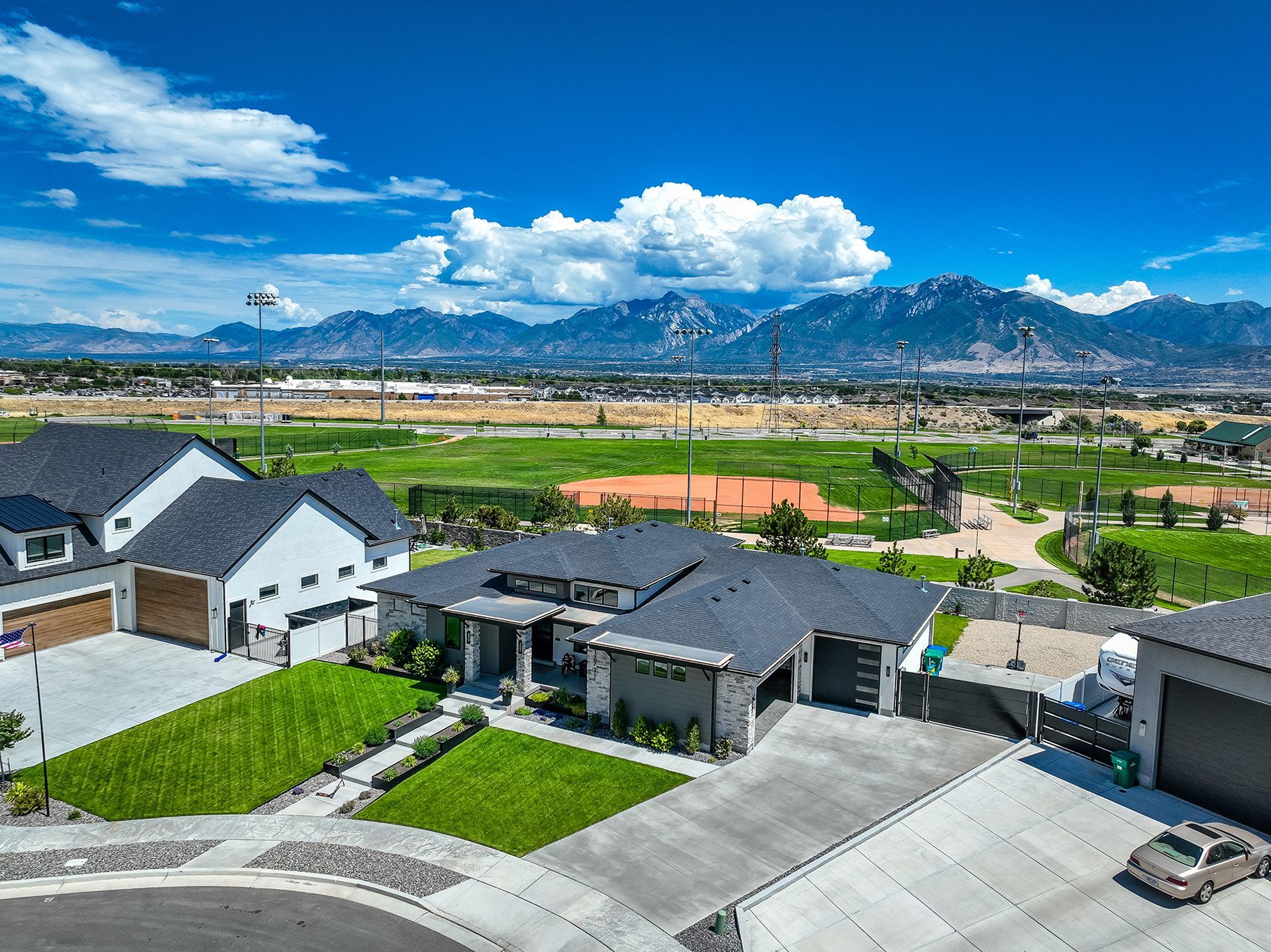 An aerial view of a residential neighborhood with mountains in the background.