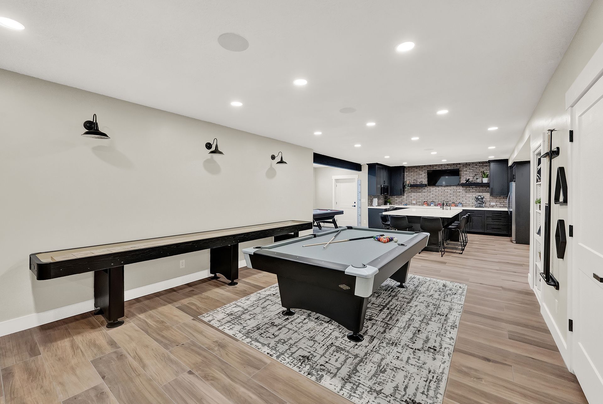 There is a pool table in the middle of the room.