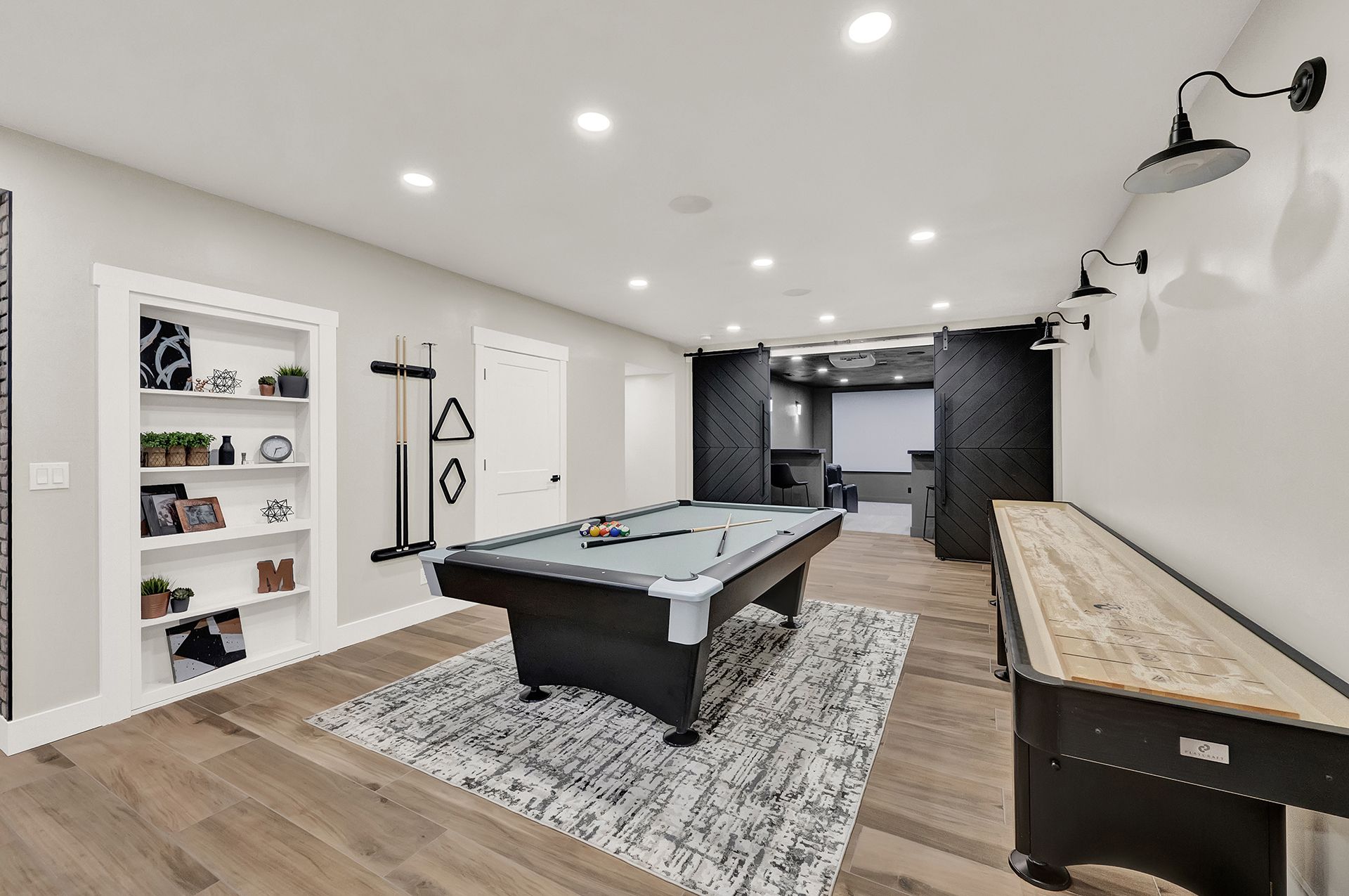 There is a pool table in the middle of the room.