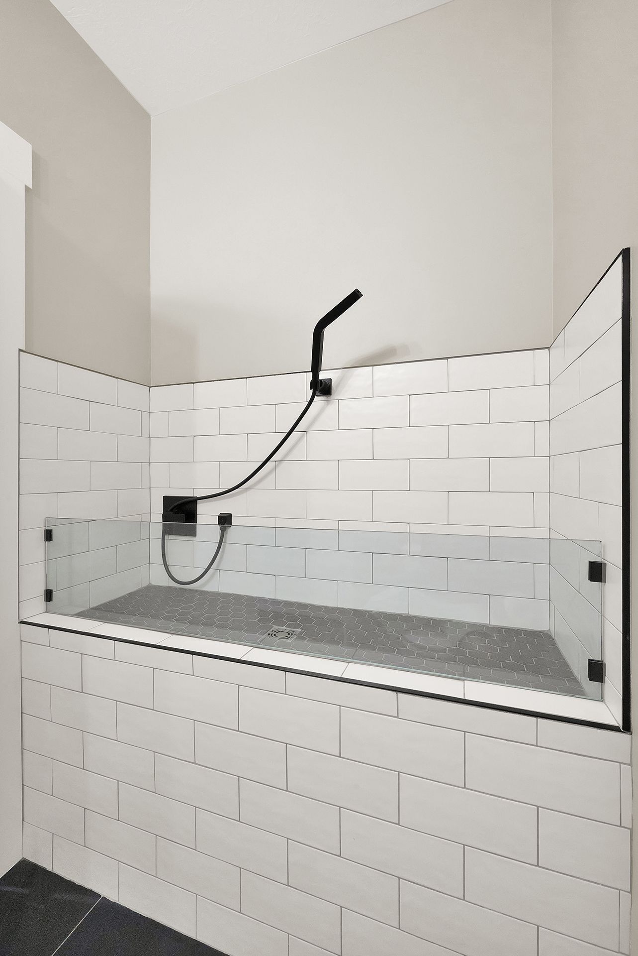 A bathtub with a shower head attached to it in a bathroom.