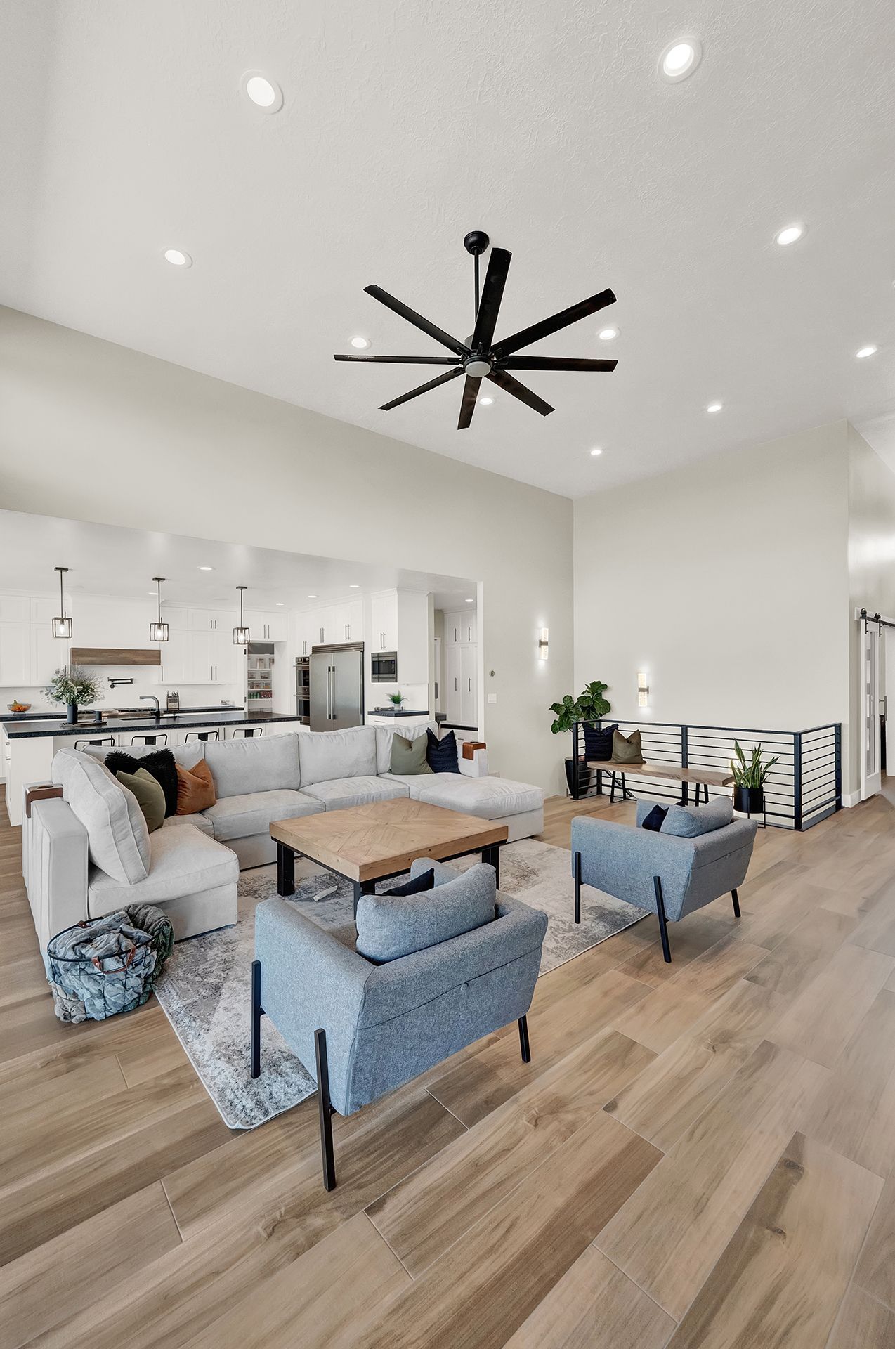 A living room filled with furniture and a ceiling fan.