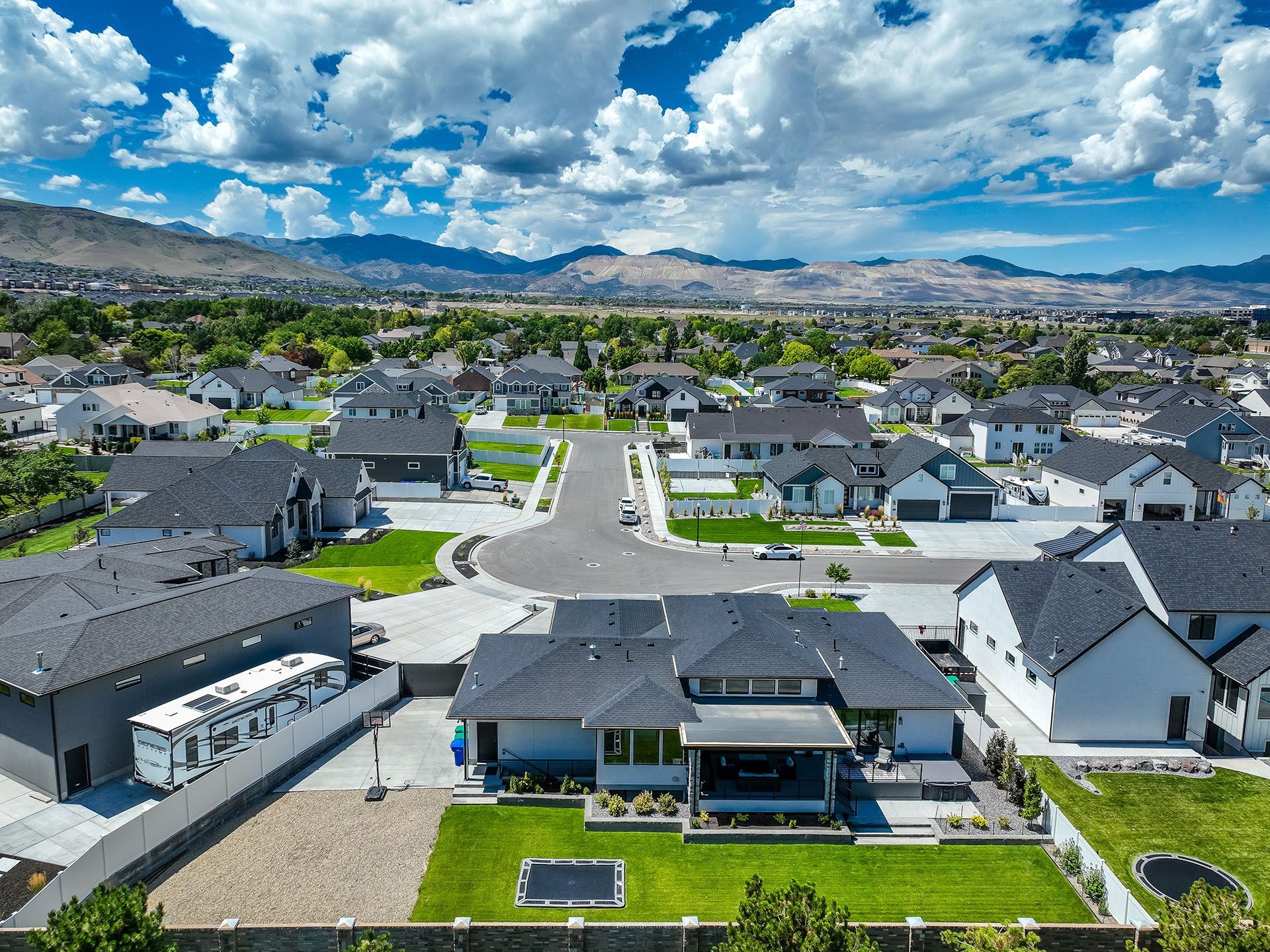 An aerial view of a residential neighborhood with mountains in the background.