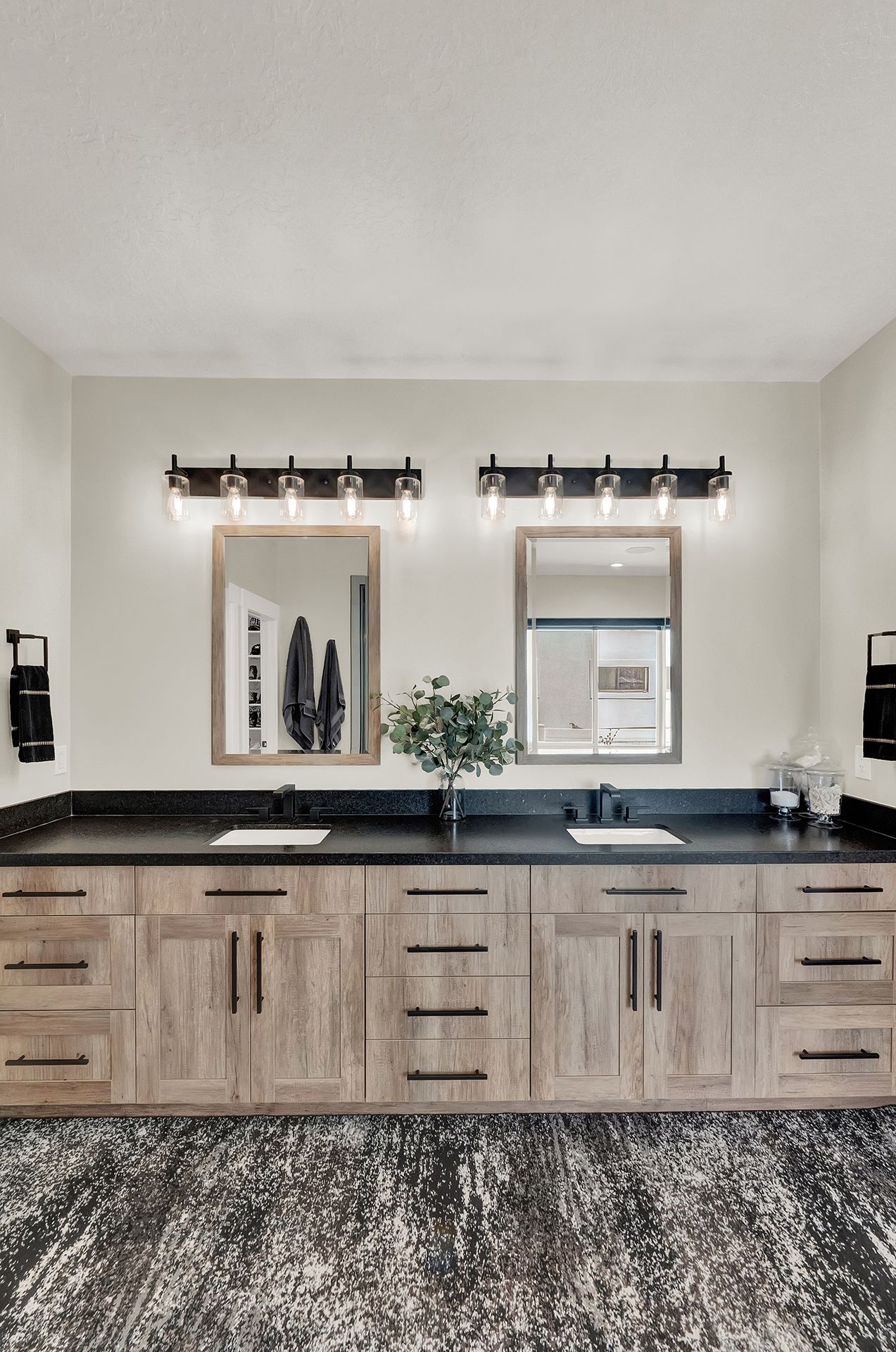 A bathroom with two sinks and two mirrors.