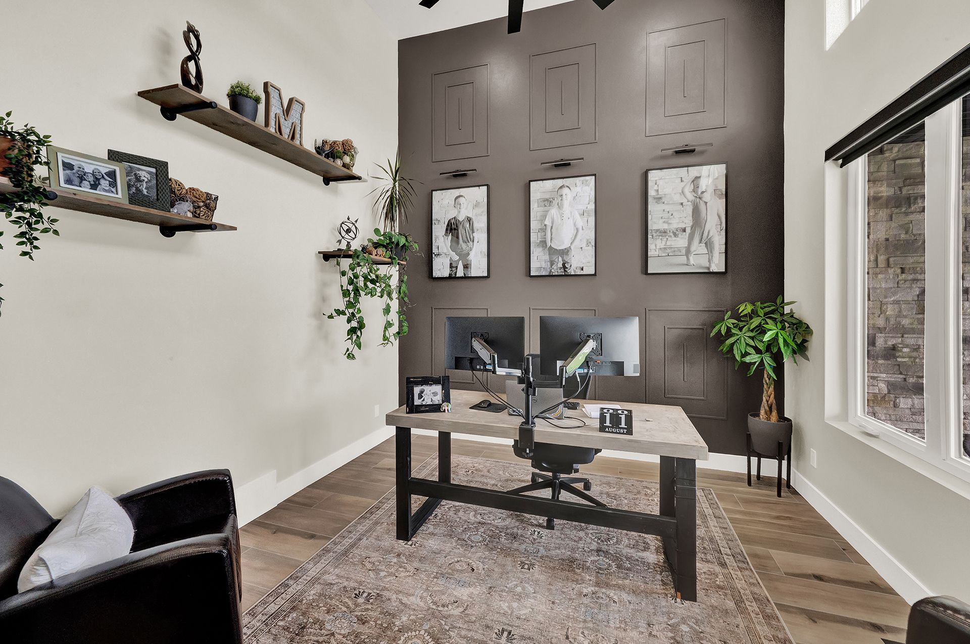 A home office with a desk , chair , and shelves.