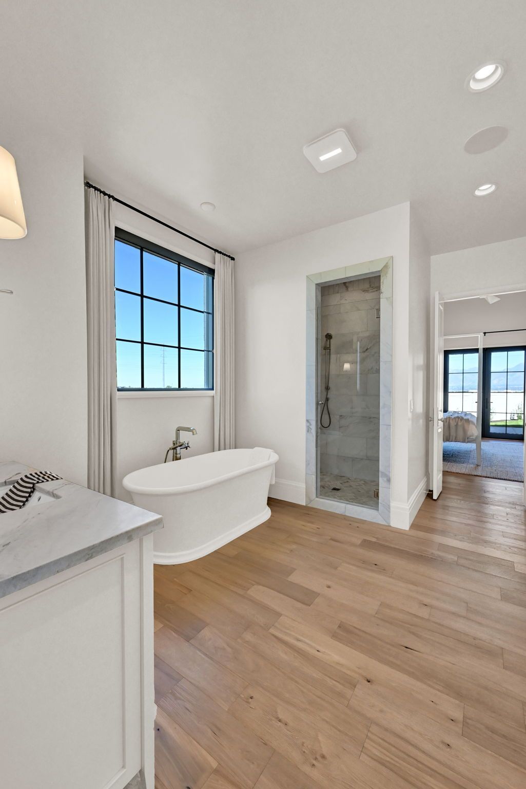 A bathroom with a tub , sink , and shower.
