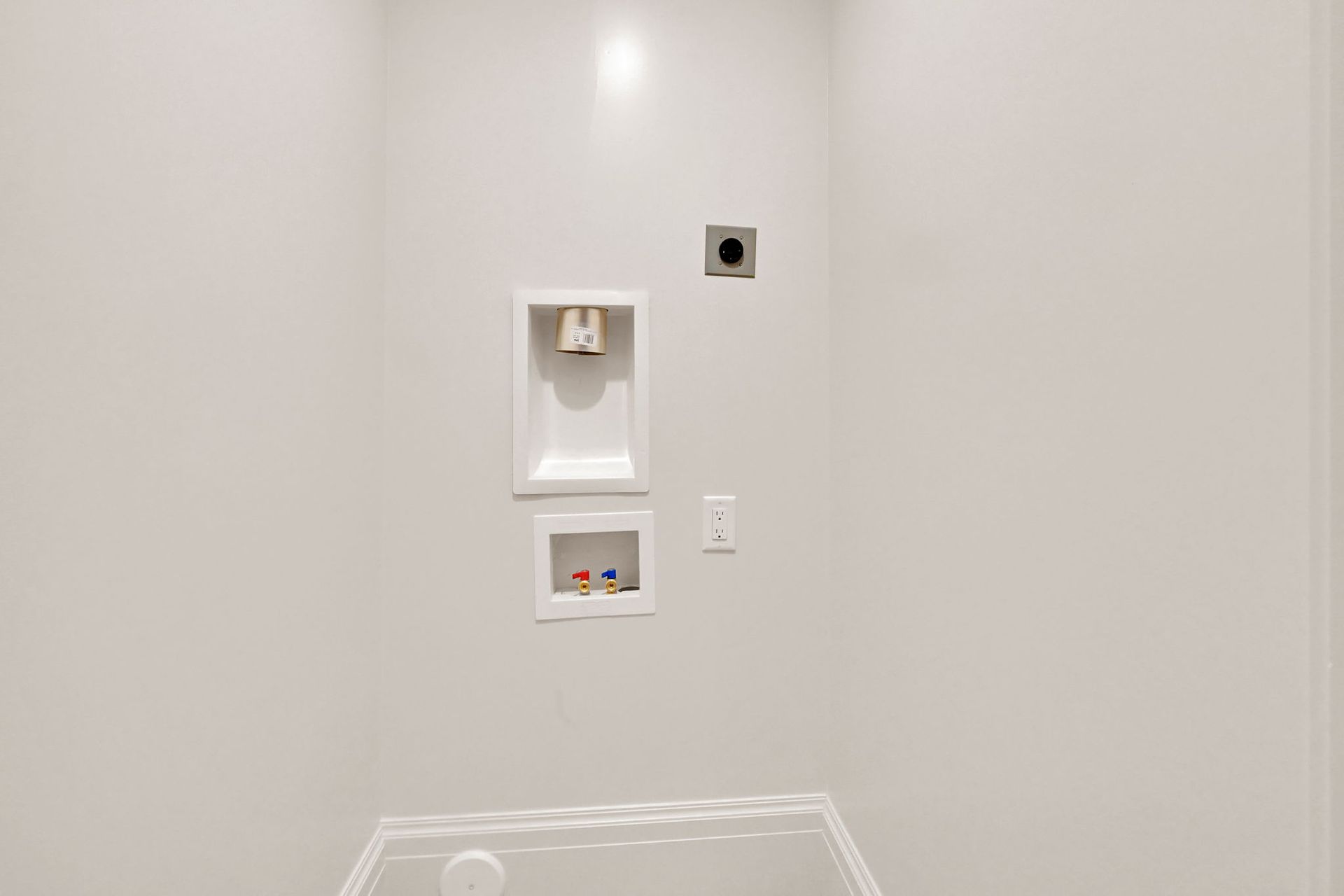 A bathroom with a tub , shower , and washer and dryer.