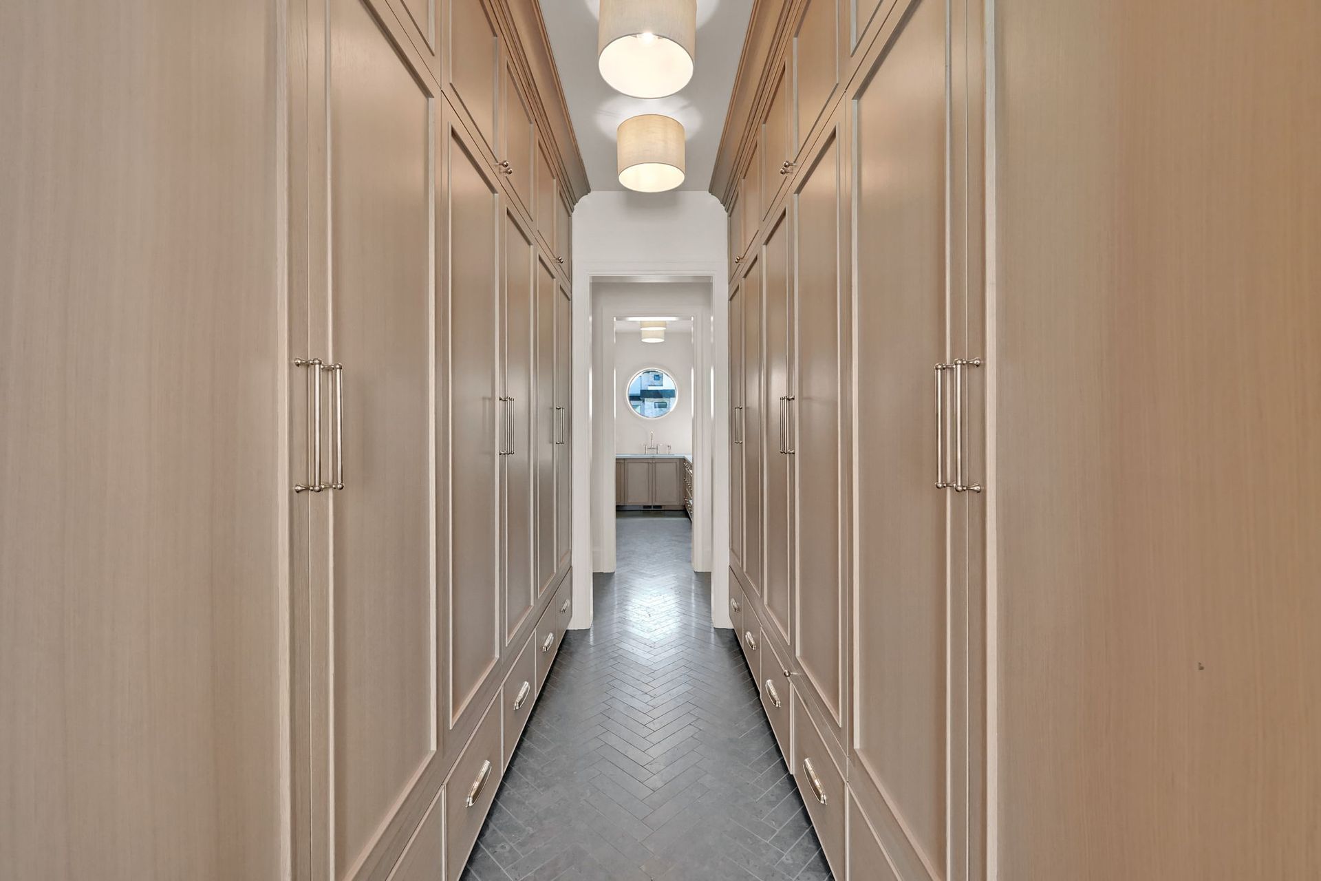 A long hallway with lots of cabinets and drawers