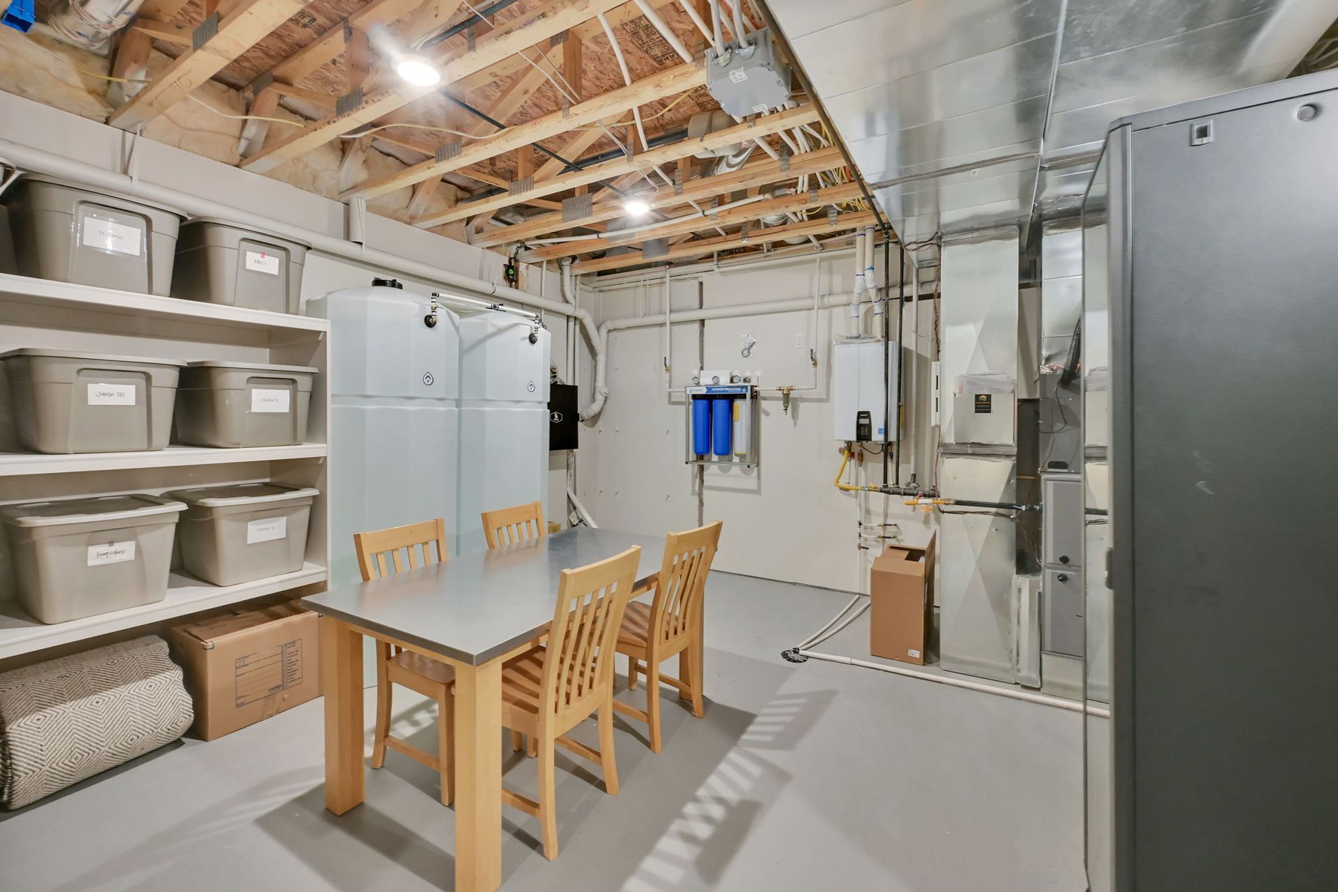 A basement with a table and chairs in it.