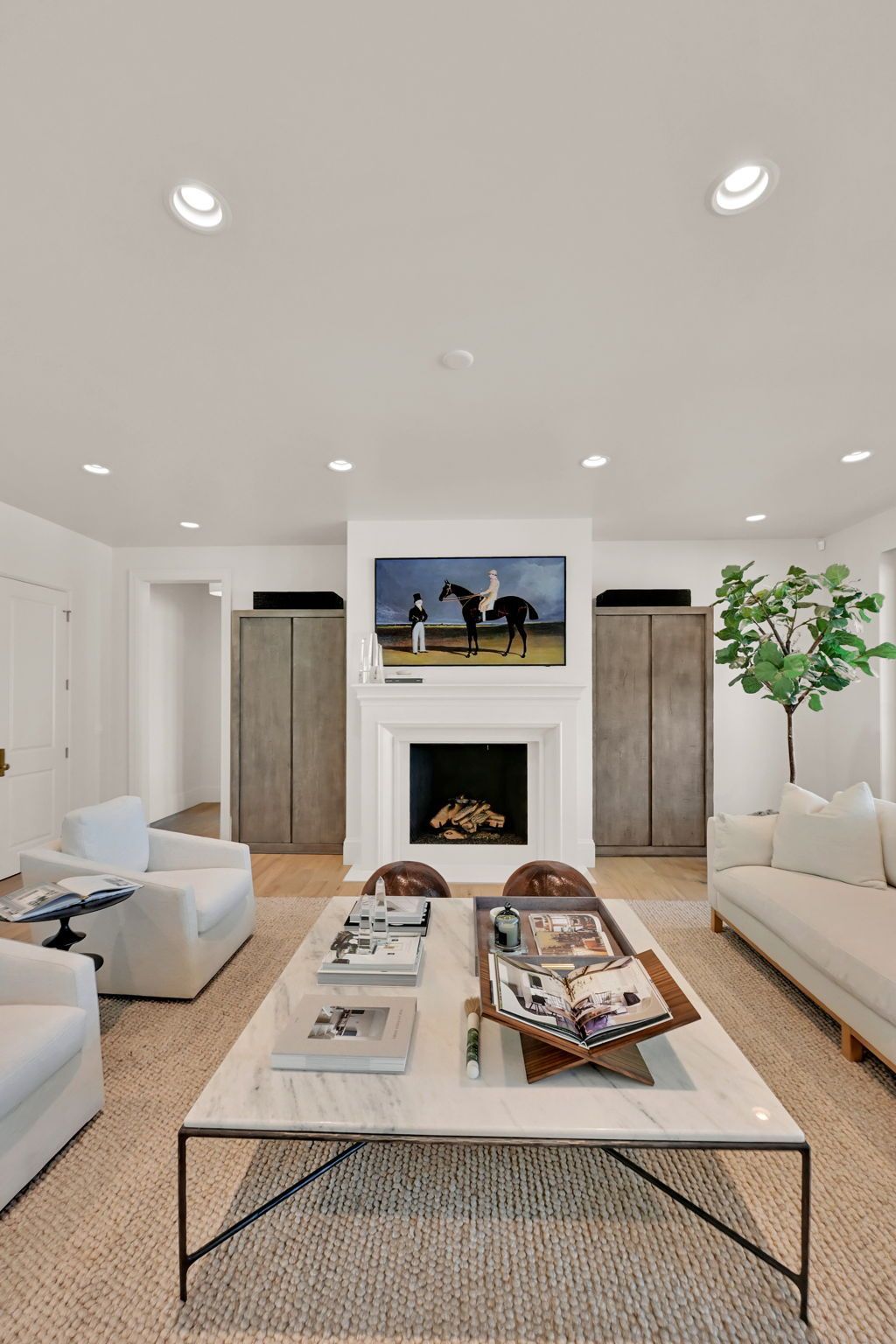 A living room with a marble coffee table and a fireplace