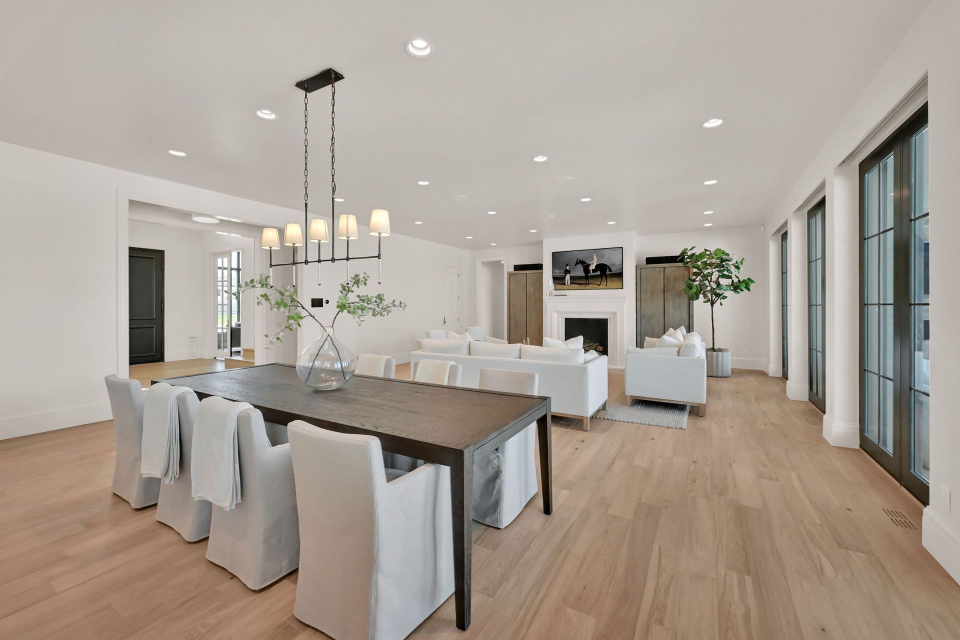 There is a dining table and chairs in the middle of the room.