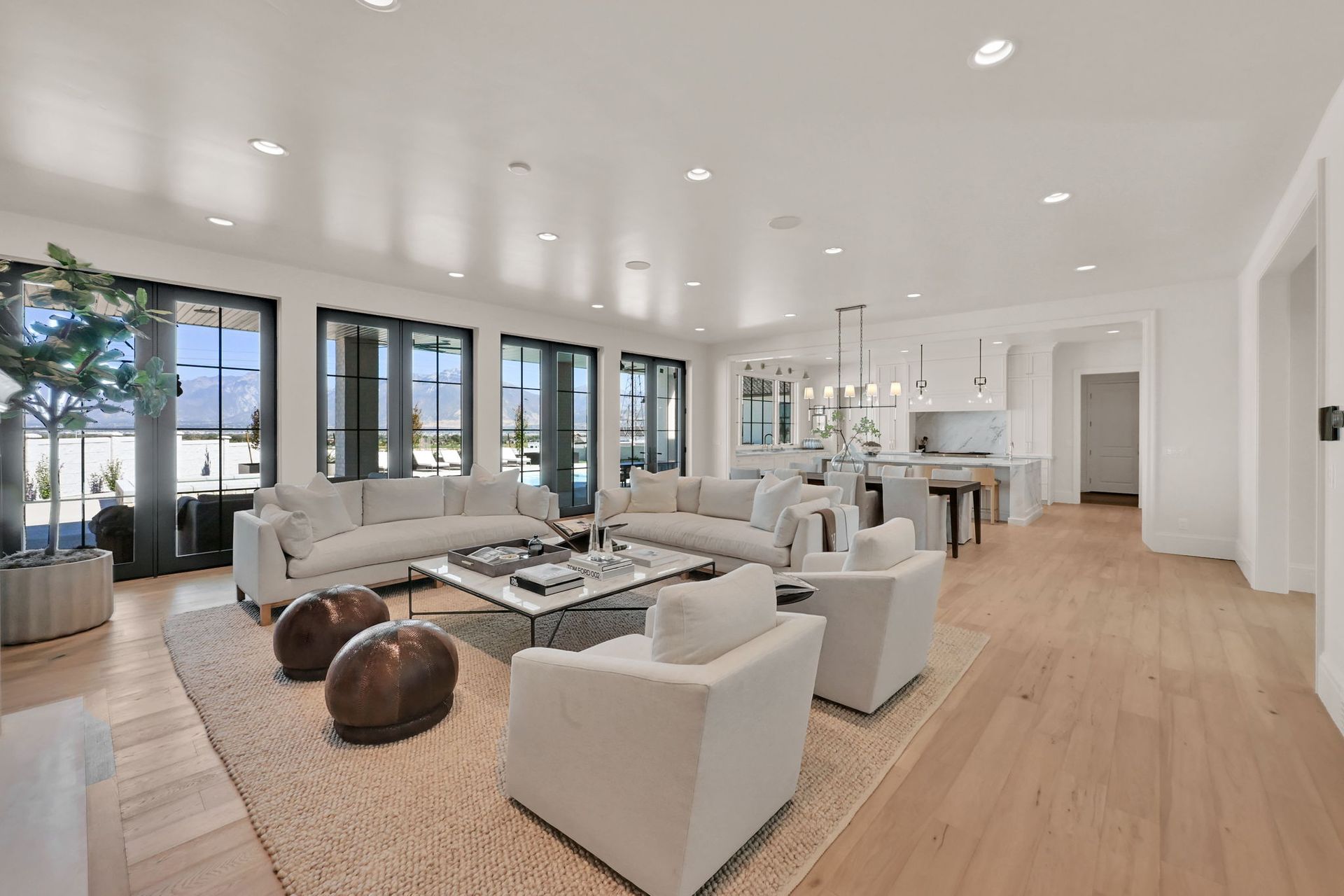 A living room with a couch , chairs , and a coffee table.