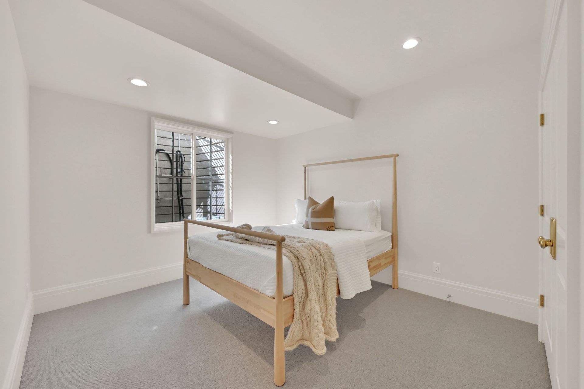 A bedroom with a bed , window and carpet.