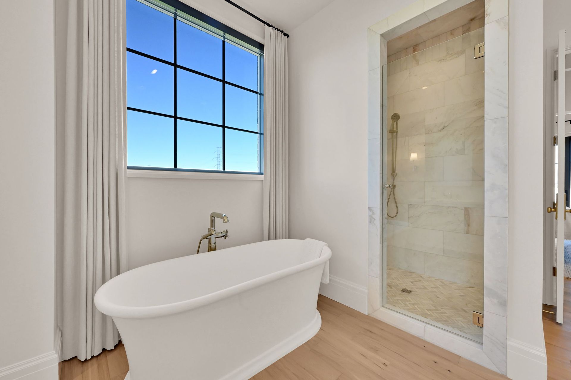 A bathroom with a bathtub and a walk in shower.