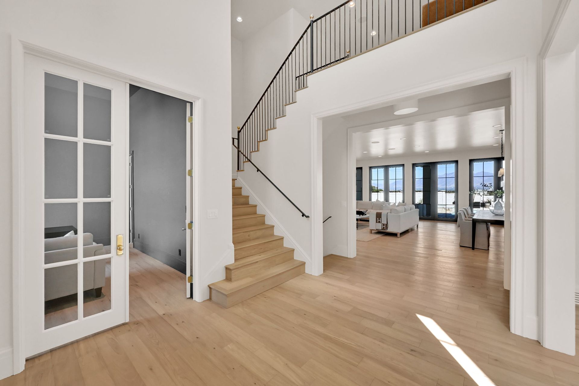 A hallway with stairs leading up to the second floor of a house.