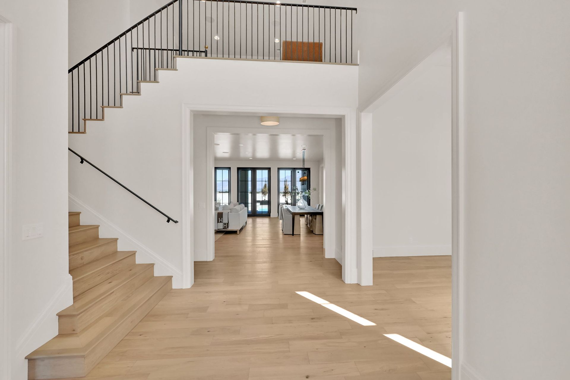 A hallway with stairs and a balcony in a house.