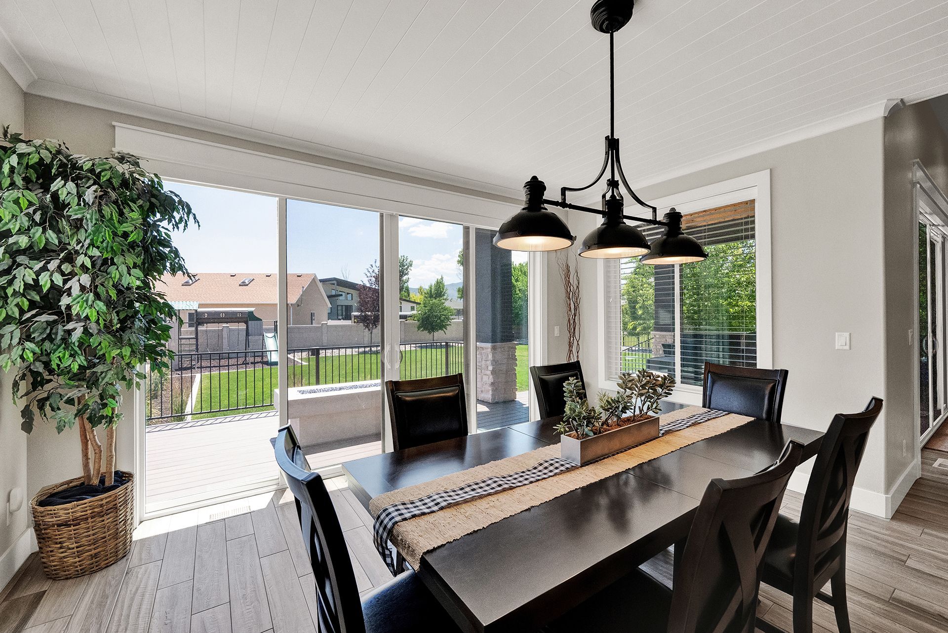 A dining room with a table and chairs and a chandelier