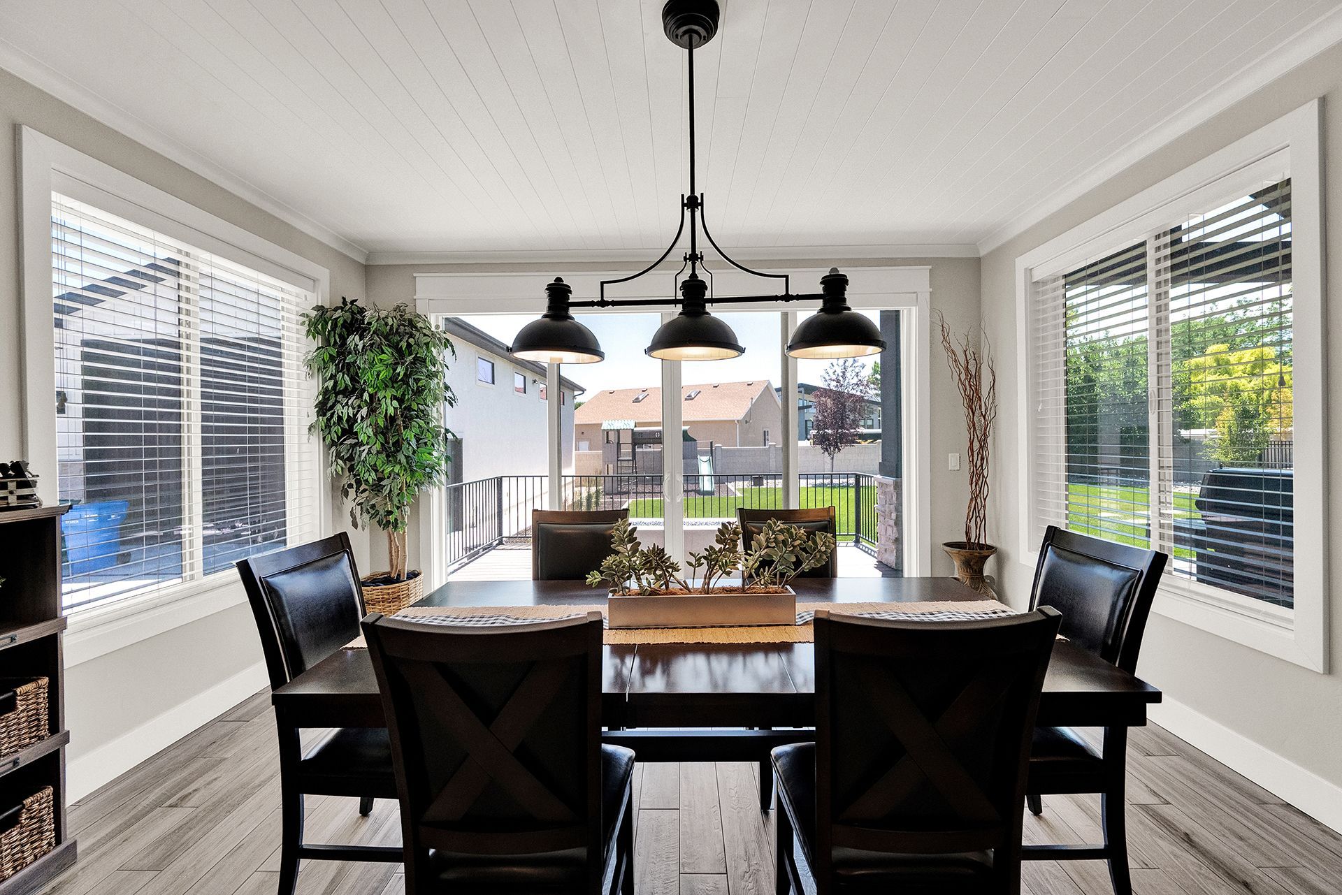 A dining room with a table and chairs and a chandelier
