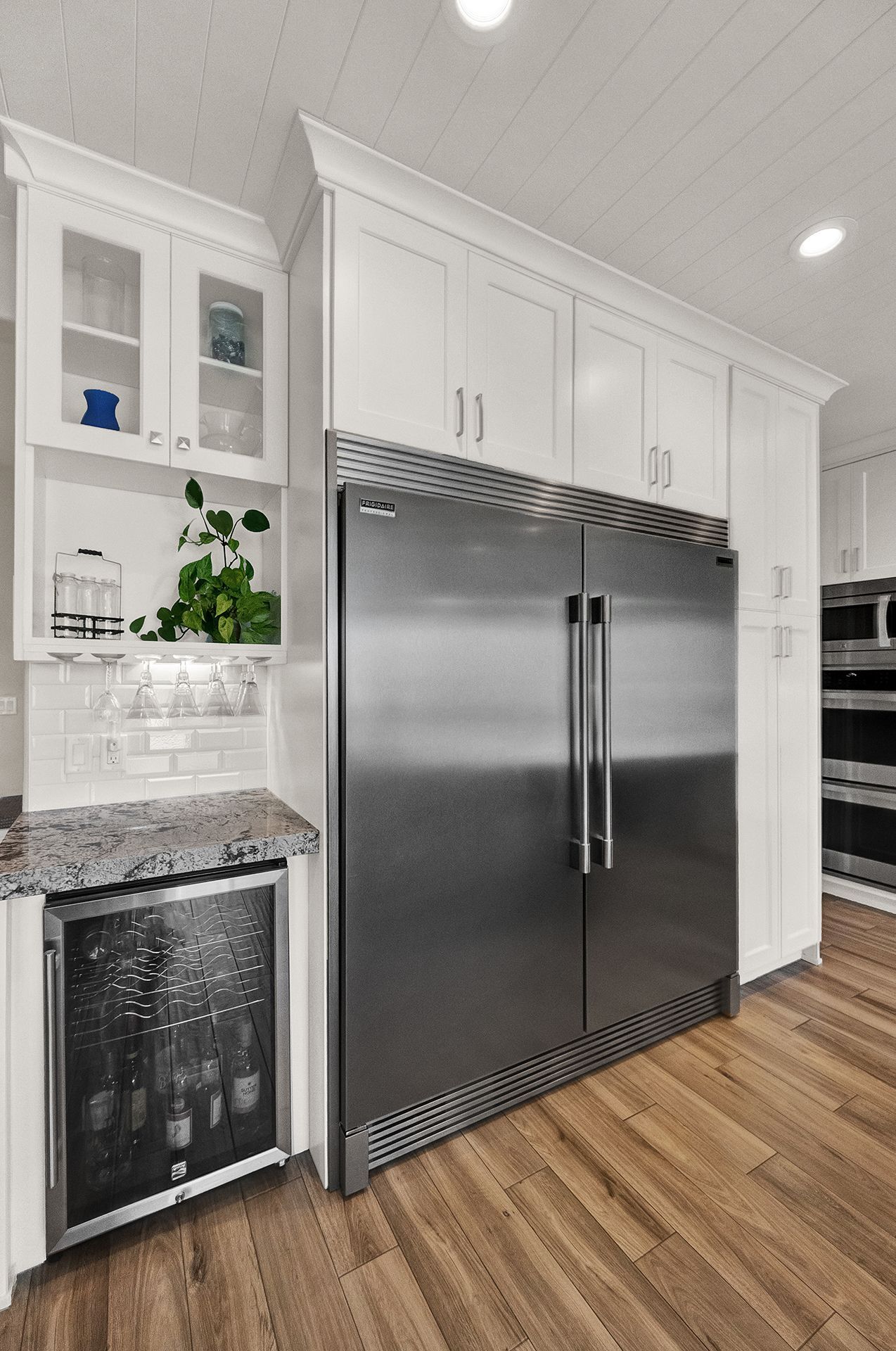 A kitchen with a stainless steel refrigerator and a wine cooler.