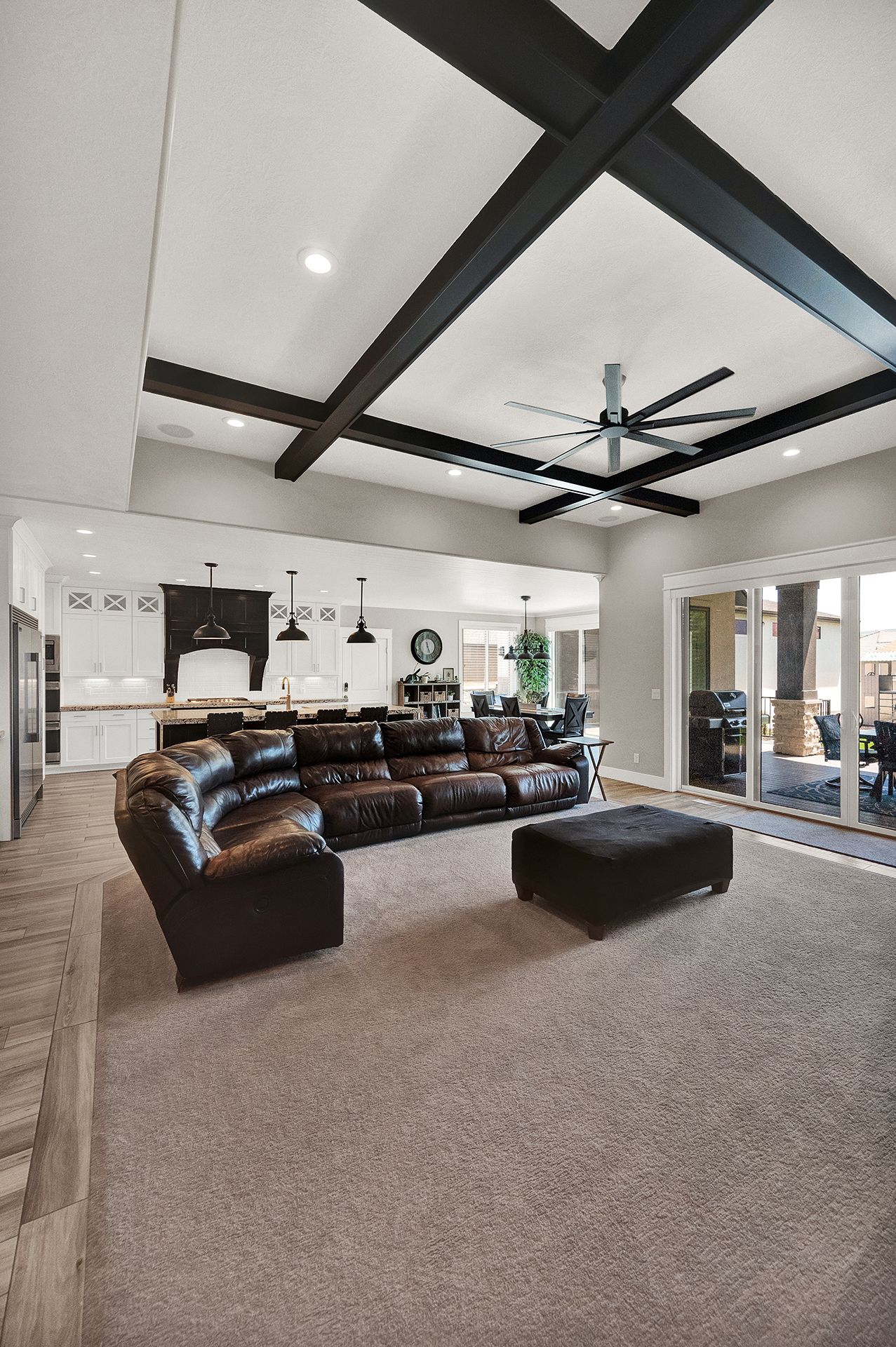 A living room filled with furniture and a ceiling fan.