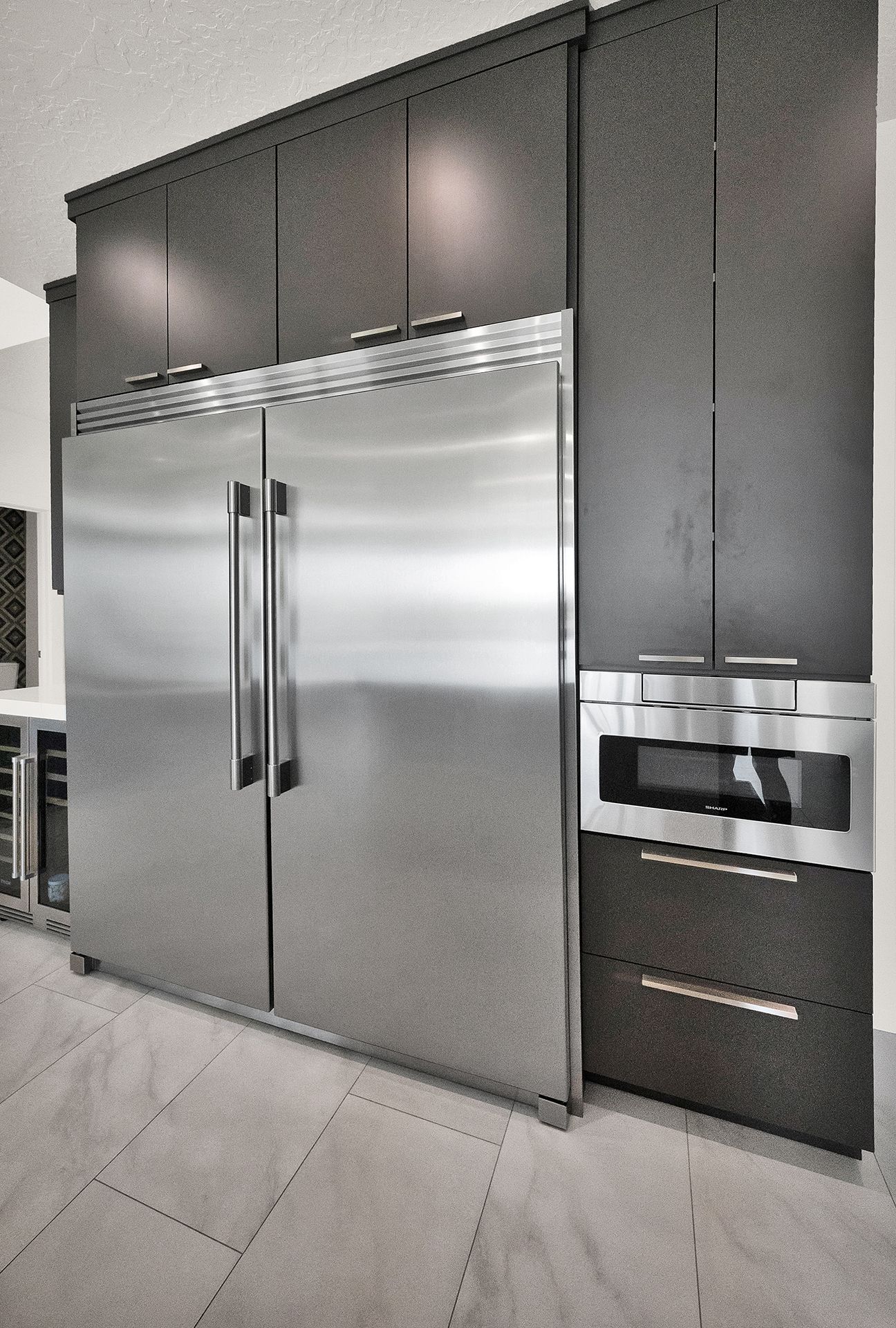 A kitchen with stainless steel appliances and black cabinets