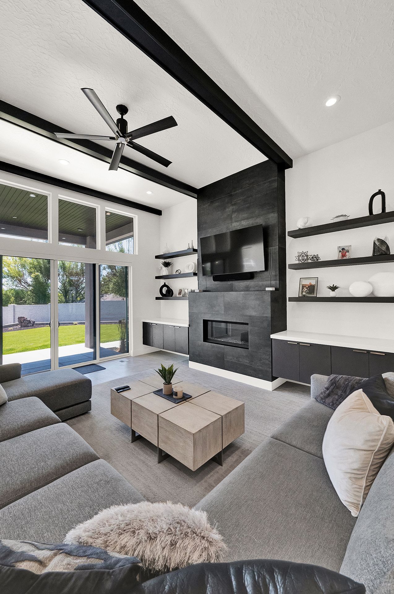 A living room with a couch , coffee table , television and fireplace.