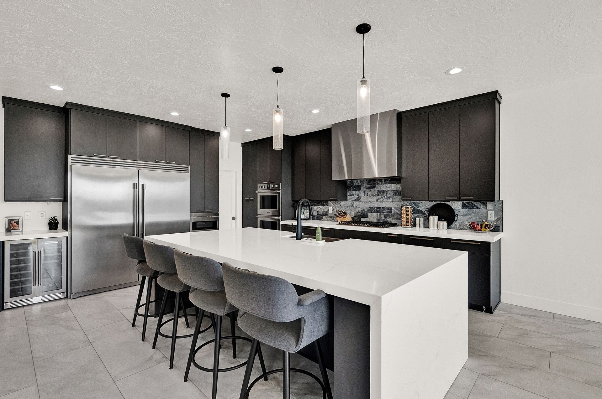 A kitchen with stainless steel appliances and a large island.