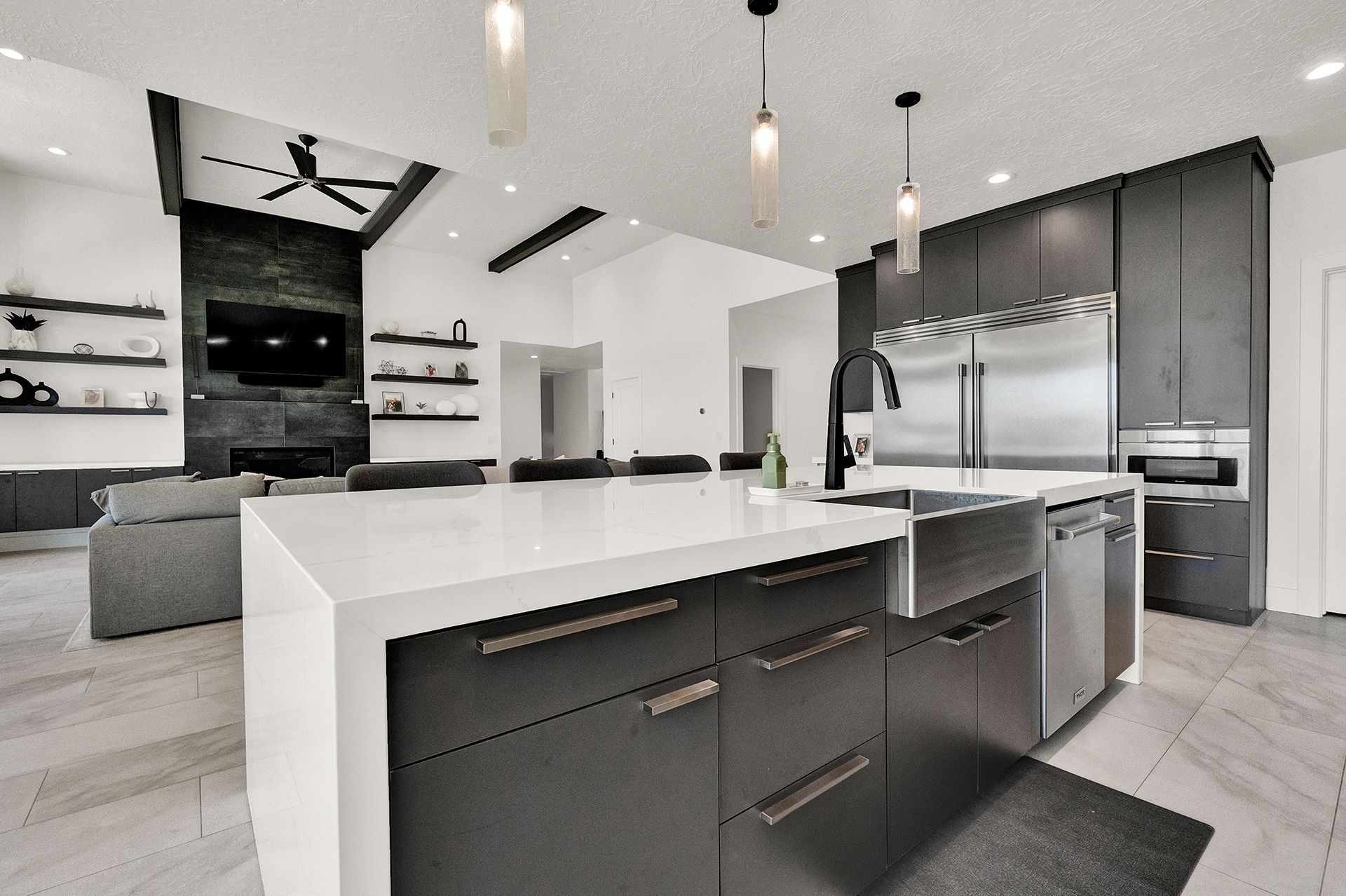 A kitchen with a large island and stainless steel appliances