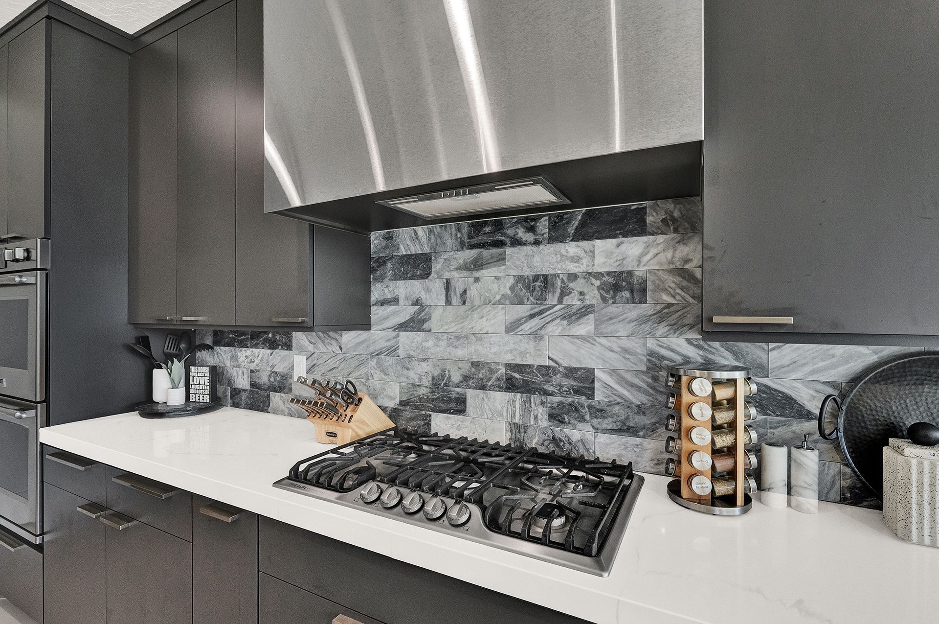 A kitchen with stainless steel appliances and a stove top oven.
