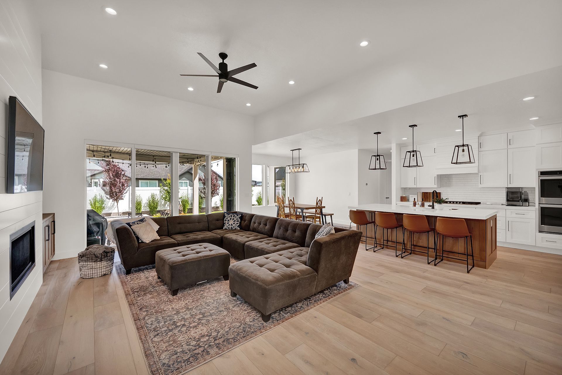 A living room filled with furniture and a ceiling fan.
