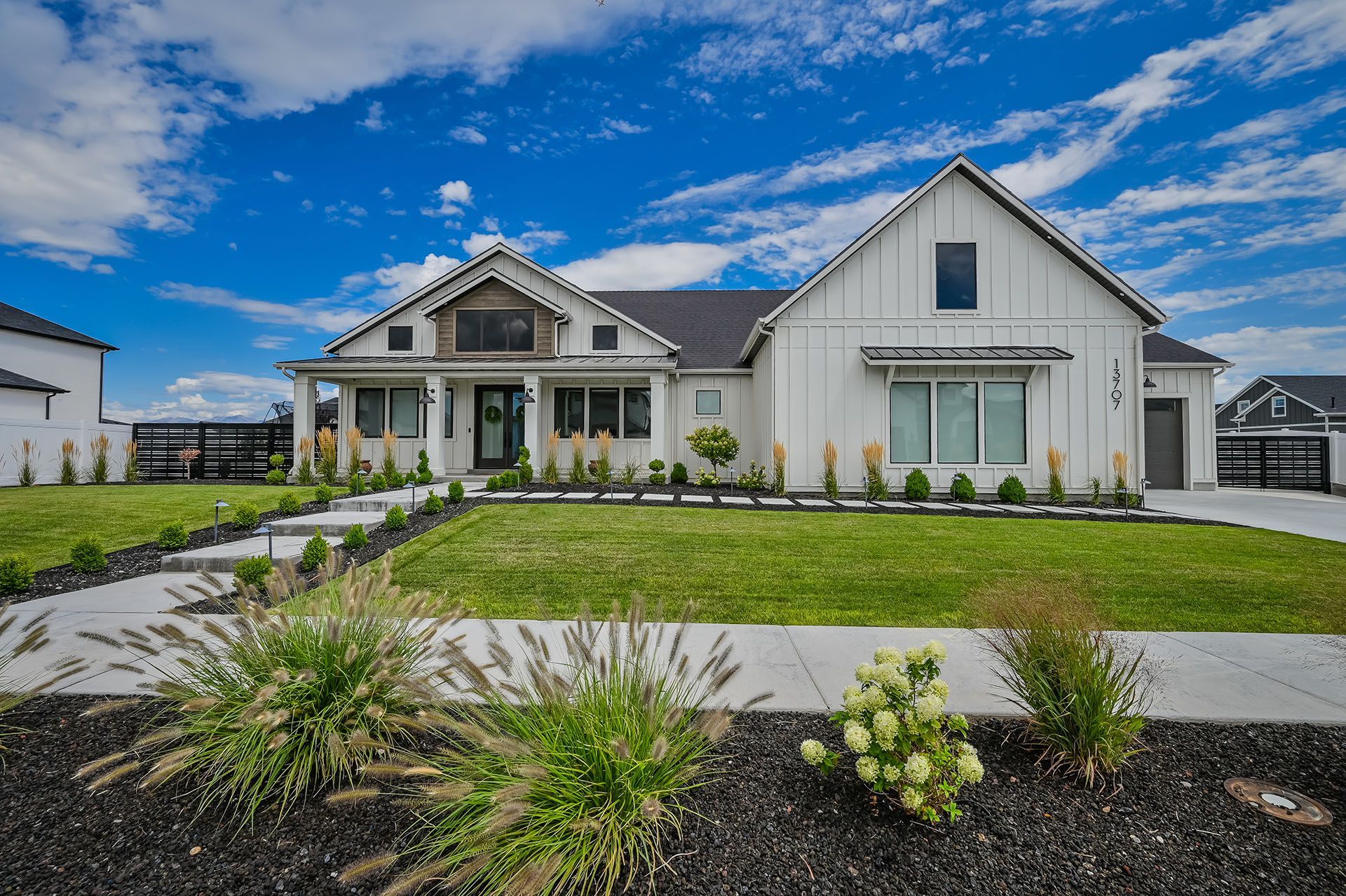 A large white house with a large lawn in front of it.