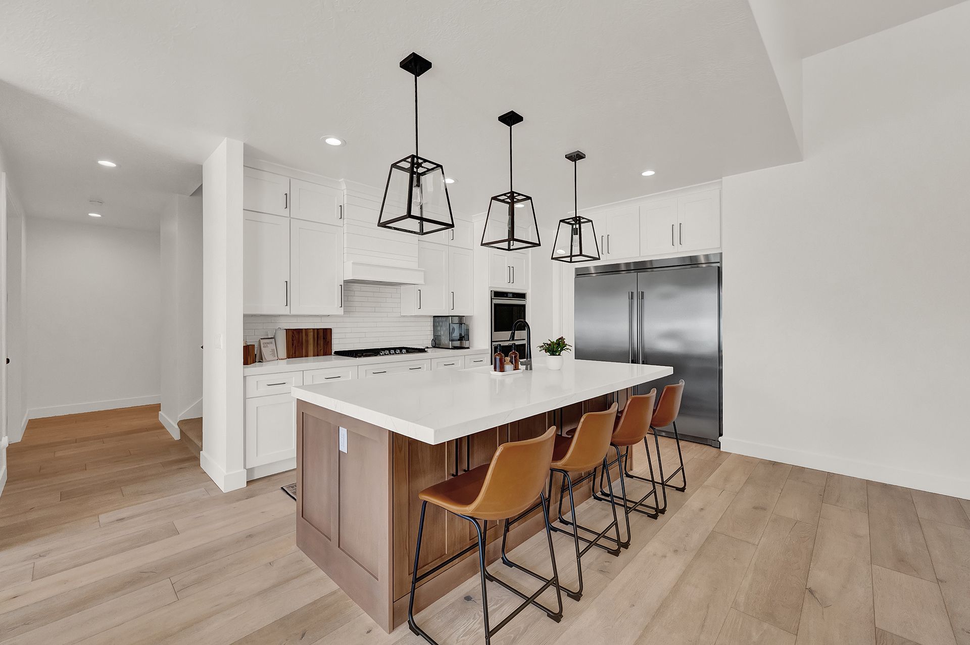 A kitchen with a large island and stools