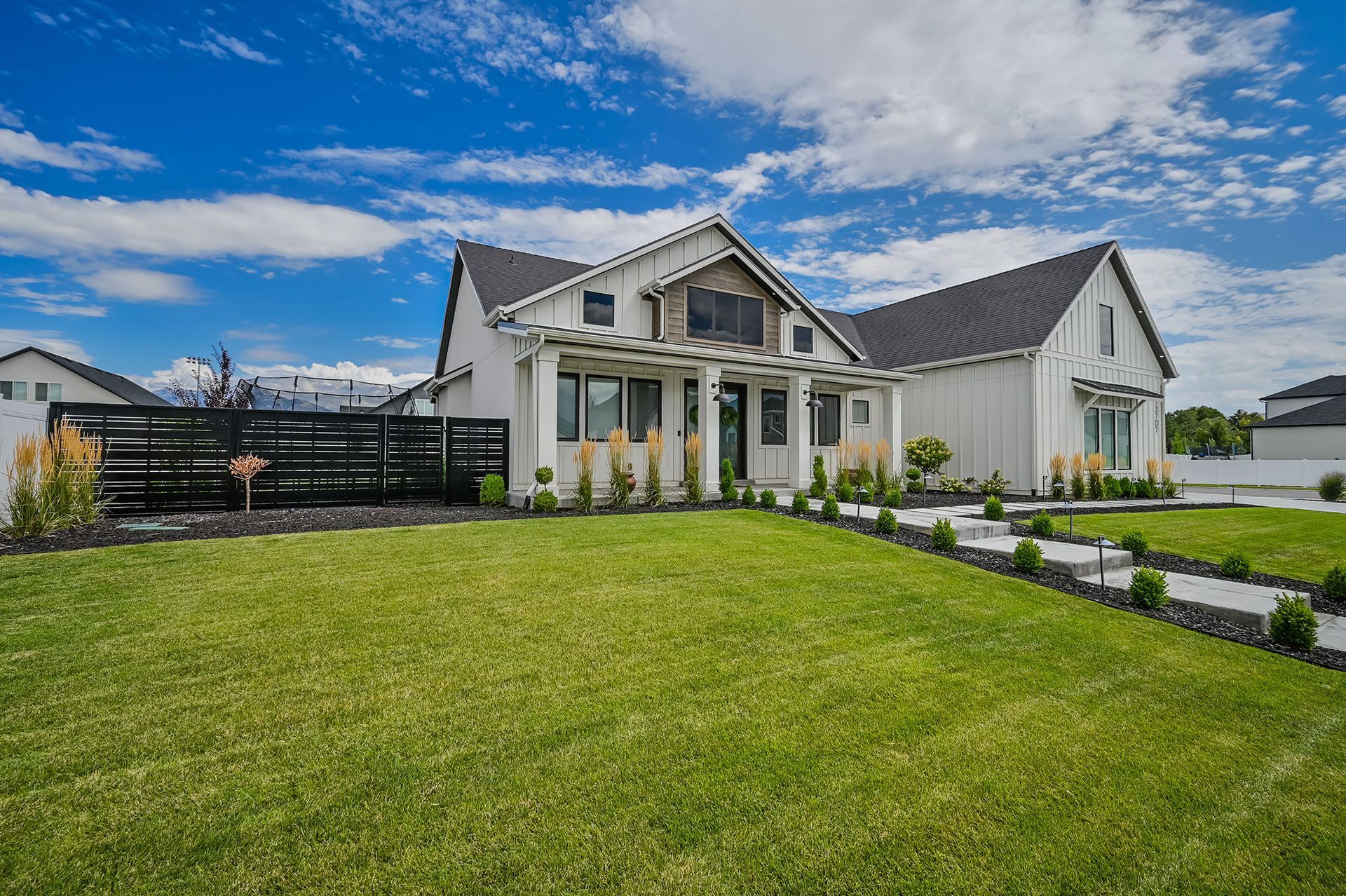A large white house with a large lawn in front of it.