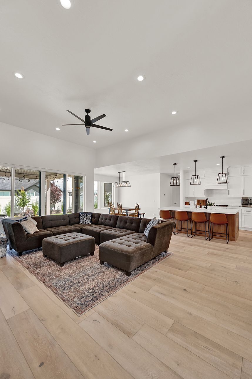 A living room filled with furniture and a ceiling fan.