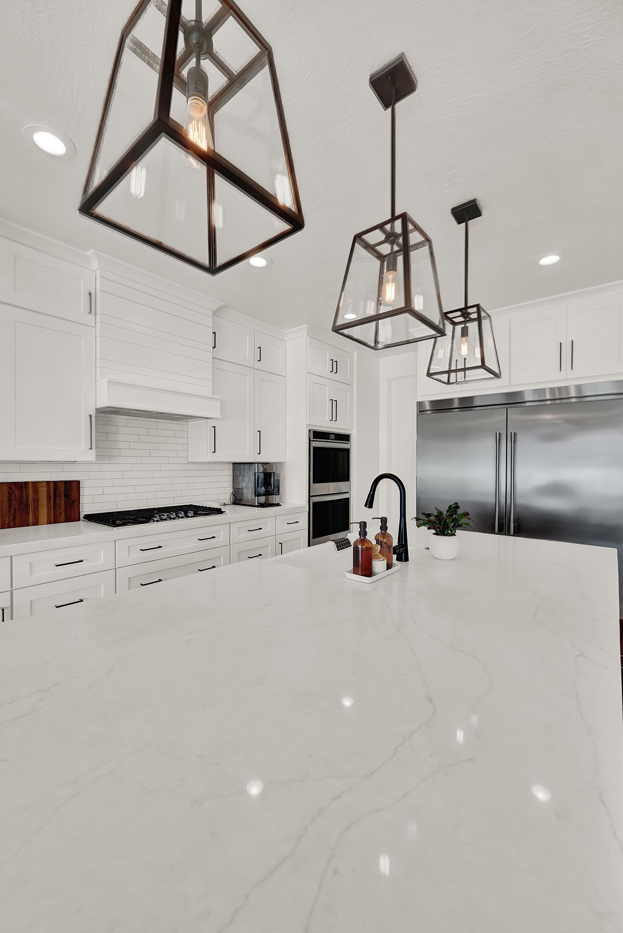 A kitchen with white cabinets and stainless steel appliances