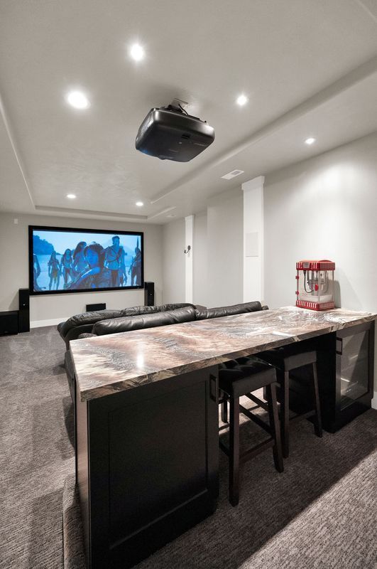 A home theater with a projector and a popcorn machine