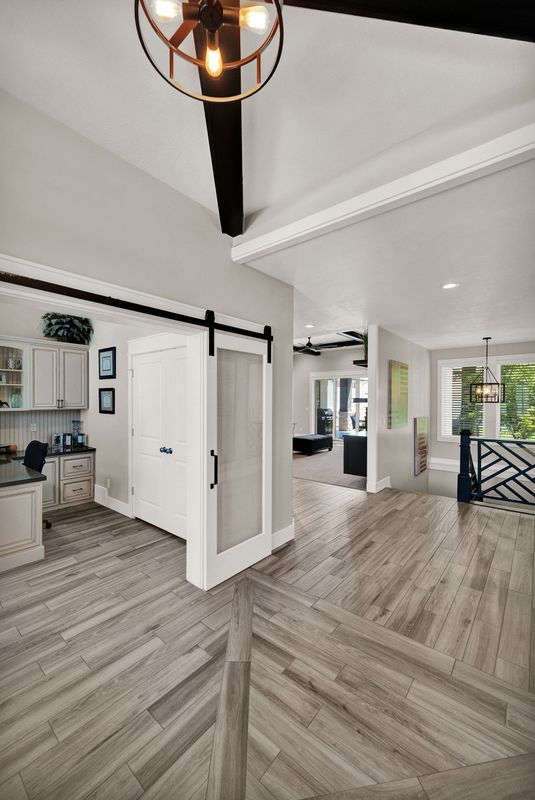 There is a sliding barn door in the middle of the room.