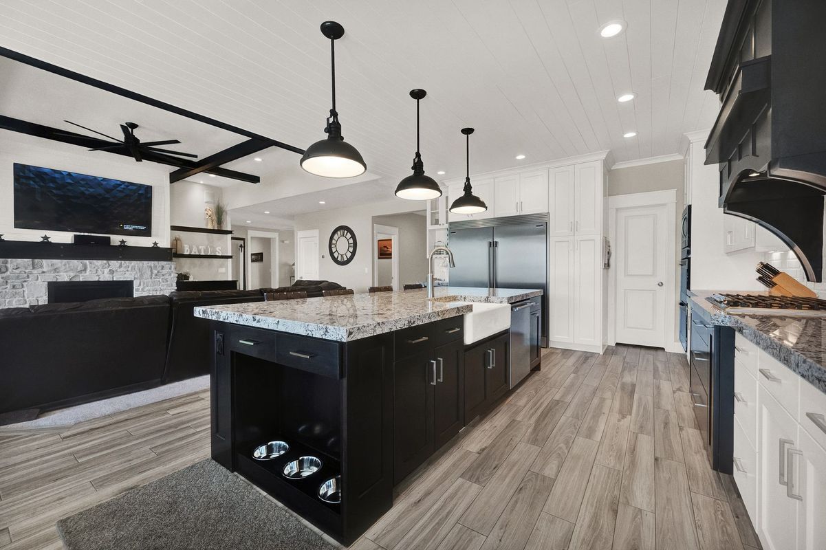 A kitchen with a large island and stainless steel appliances