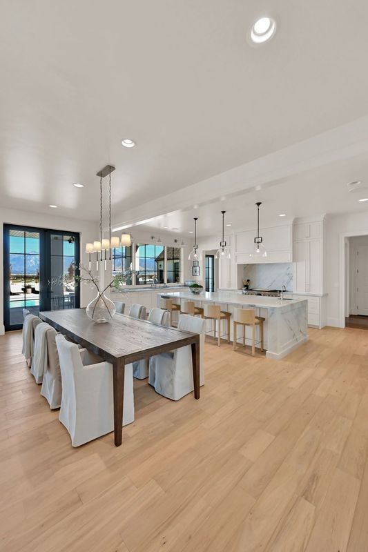 There is a dining table and chairs in the middle of the room.